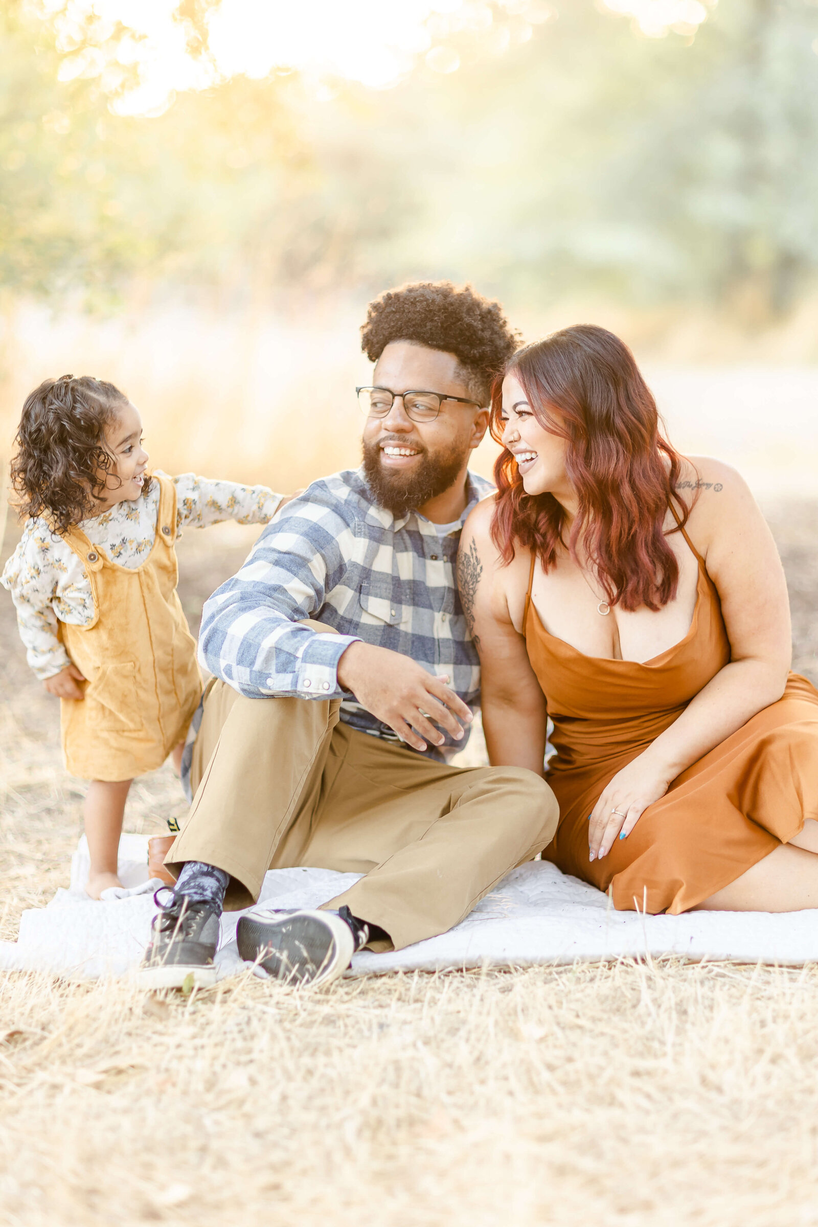 A family smiling at each other during a photoshoot
