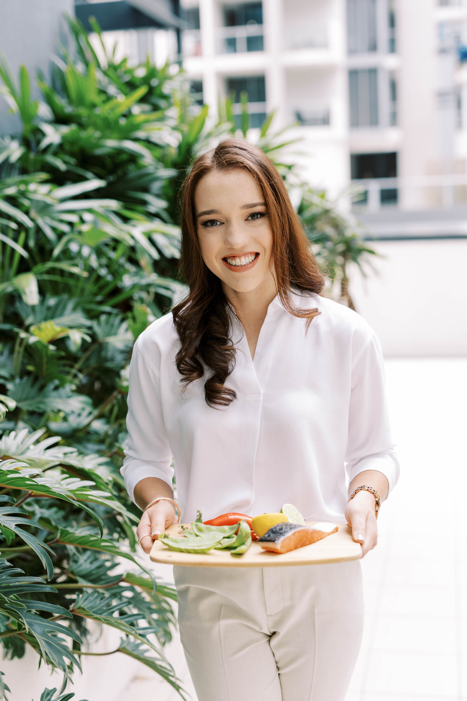 Dedicated dietitian in Brisbane offering a platter of nutritious foods, symbolising a balanced approach to gut health