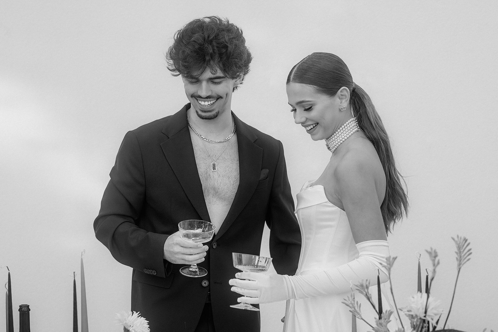 Wedding couple holds Champagne-glasses during reception.