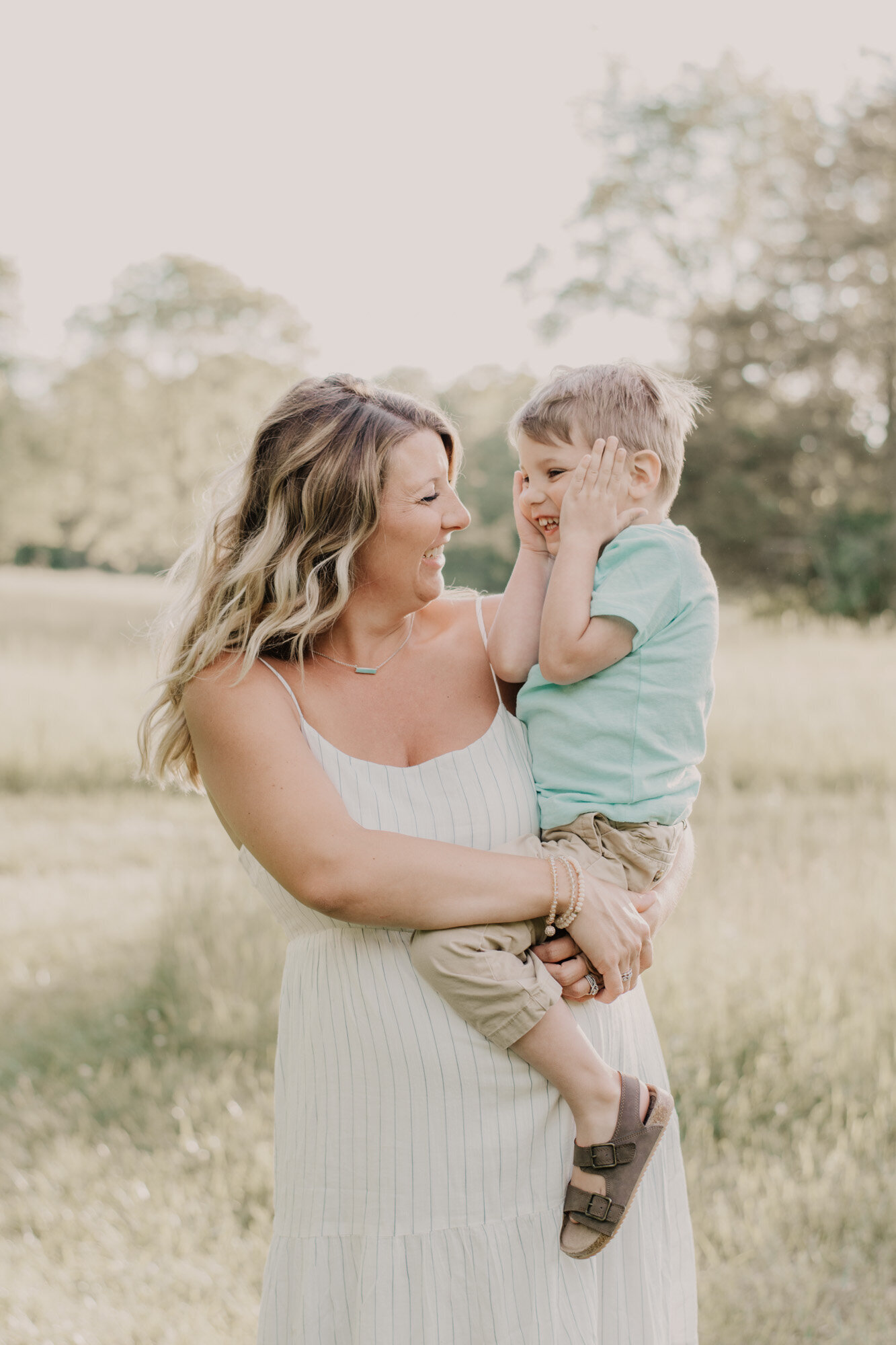 Mom and baby brother are looking and smiling at each other