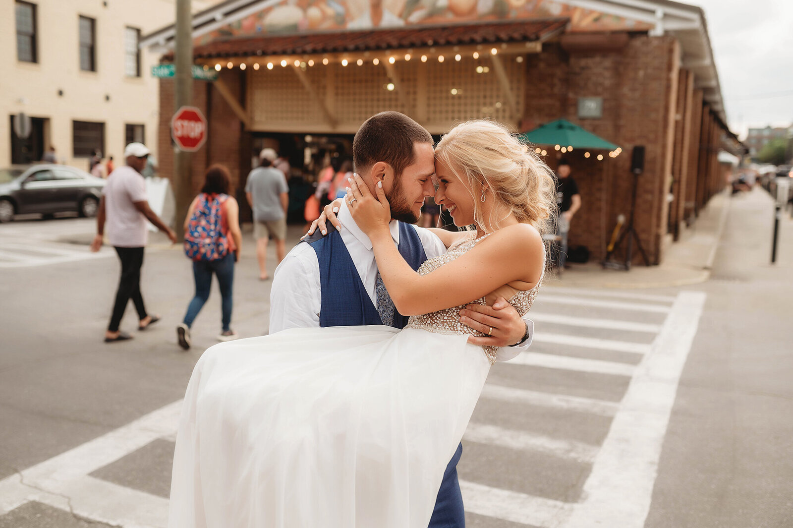 Bride and Groom dance in the street in front of the city market after their Micro-Wedding Ceremony in Charleston, SC.