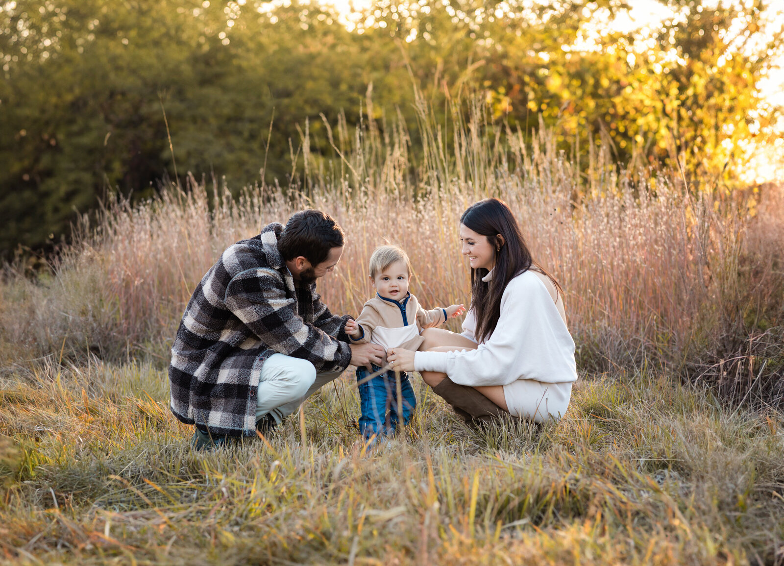 mom and dad with son at park for family photos 