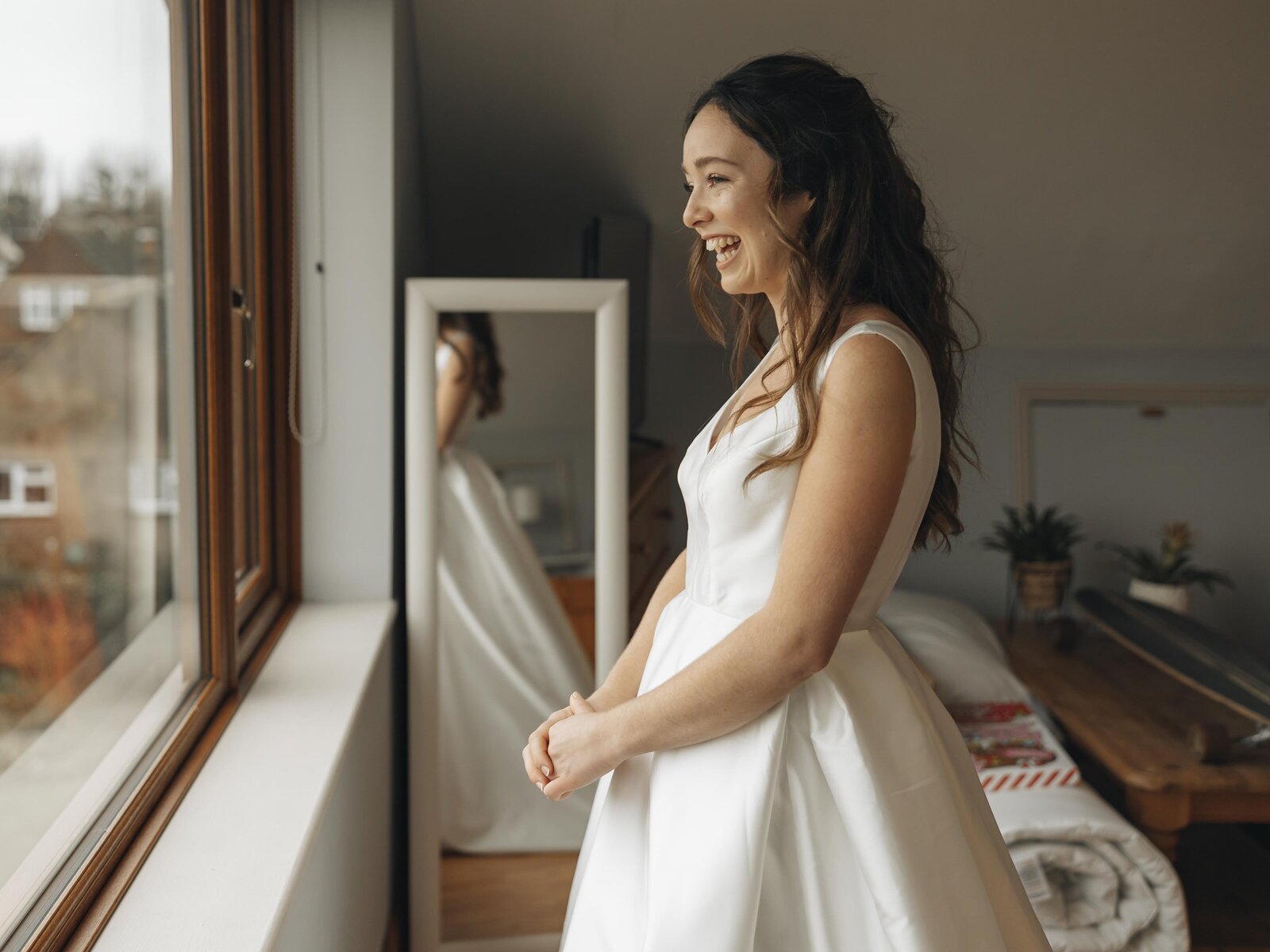 bride looking out of the window smiling