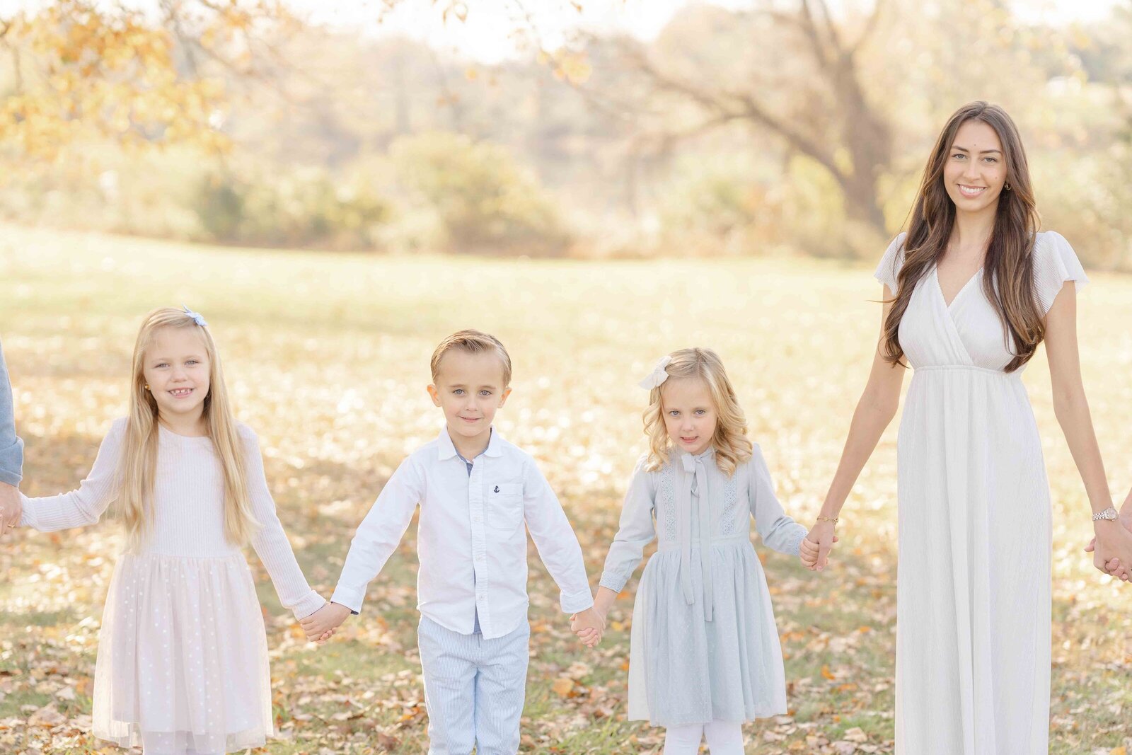 kids holding hands during fall mini session in Haymarket, VA