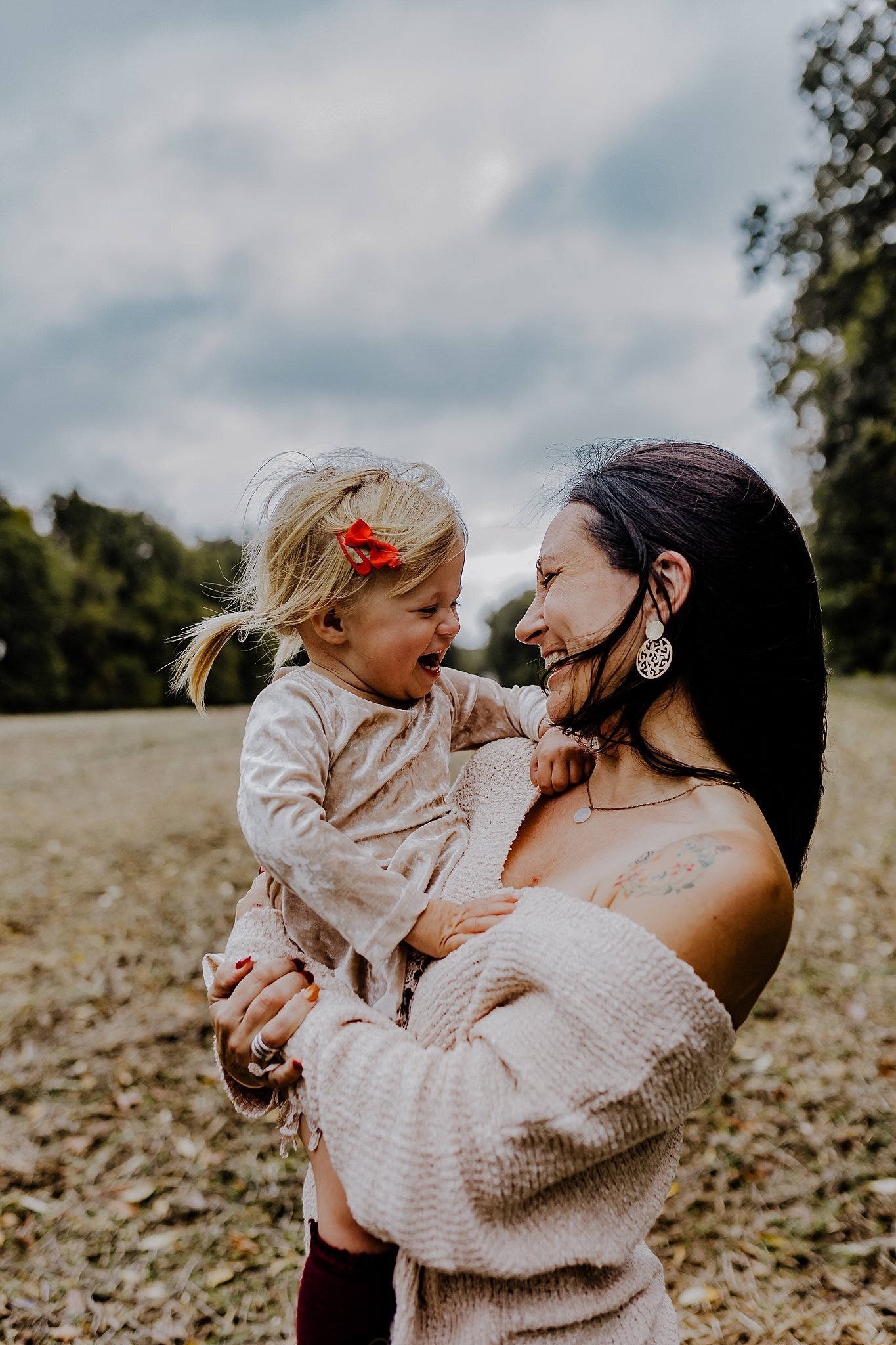 mom with daughter holding and laughing