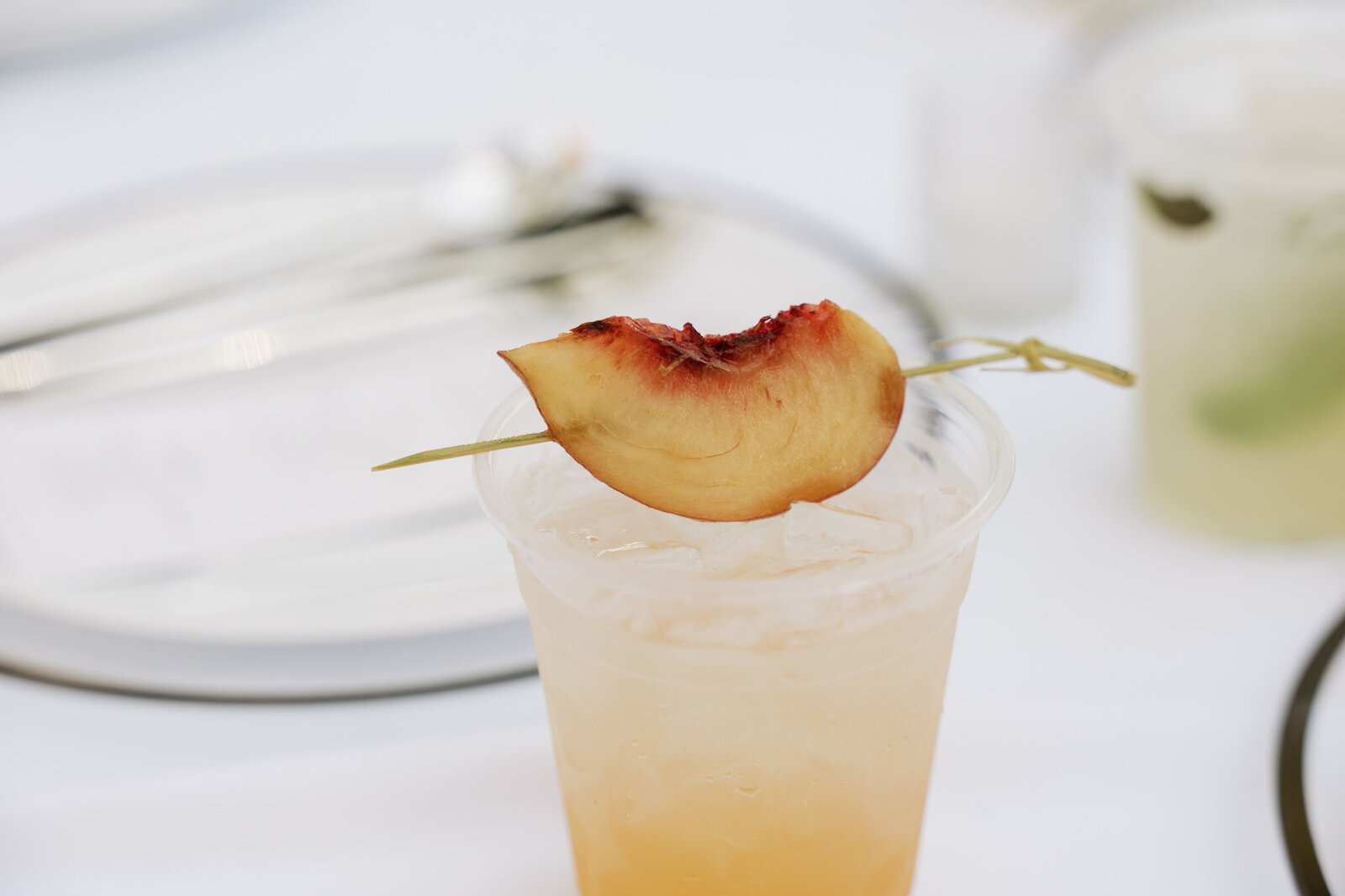 Specialty cocktail with peach topping and greenery at Nelson Family Vineyards wedding venue