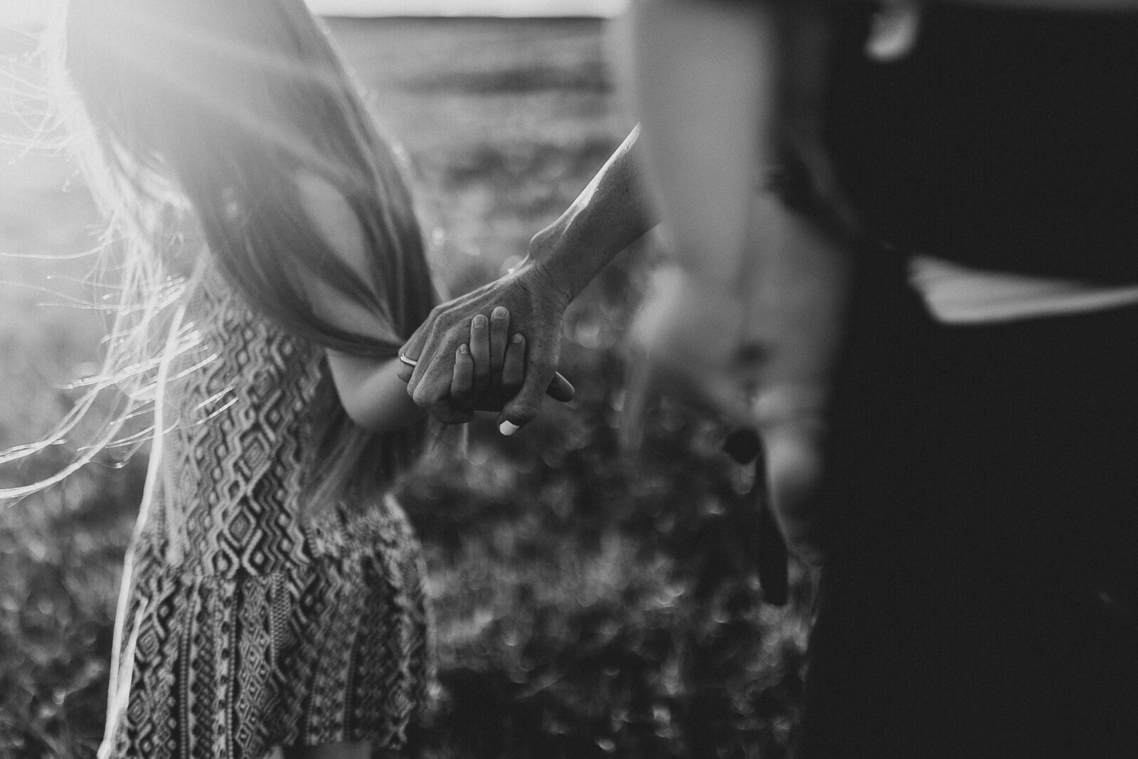 Mother holds daughters hand in open Iowa field