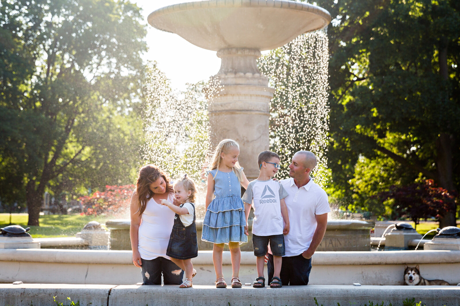 family in front of big fountain