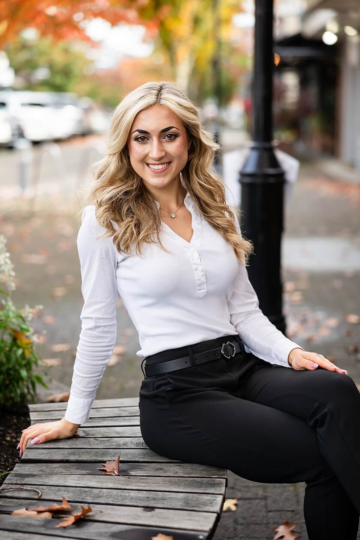 Confident woman sitting on a bench during a Seattle branding photography session—an example of personal branding photography that blends professionalism and approachability. Captured by a brand photographer near me specializing in she plays with fire visuals.