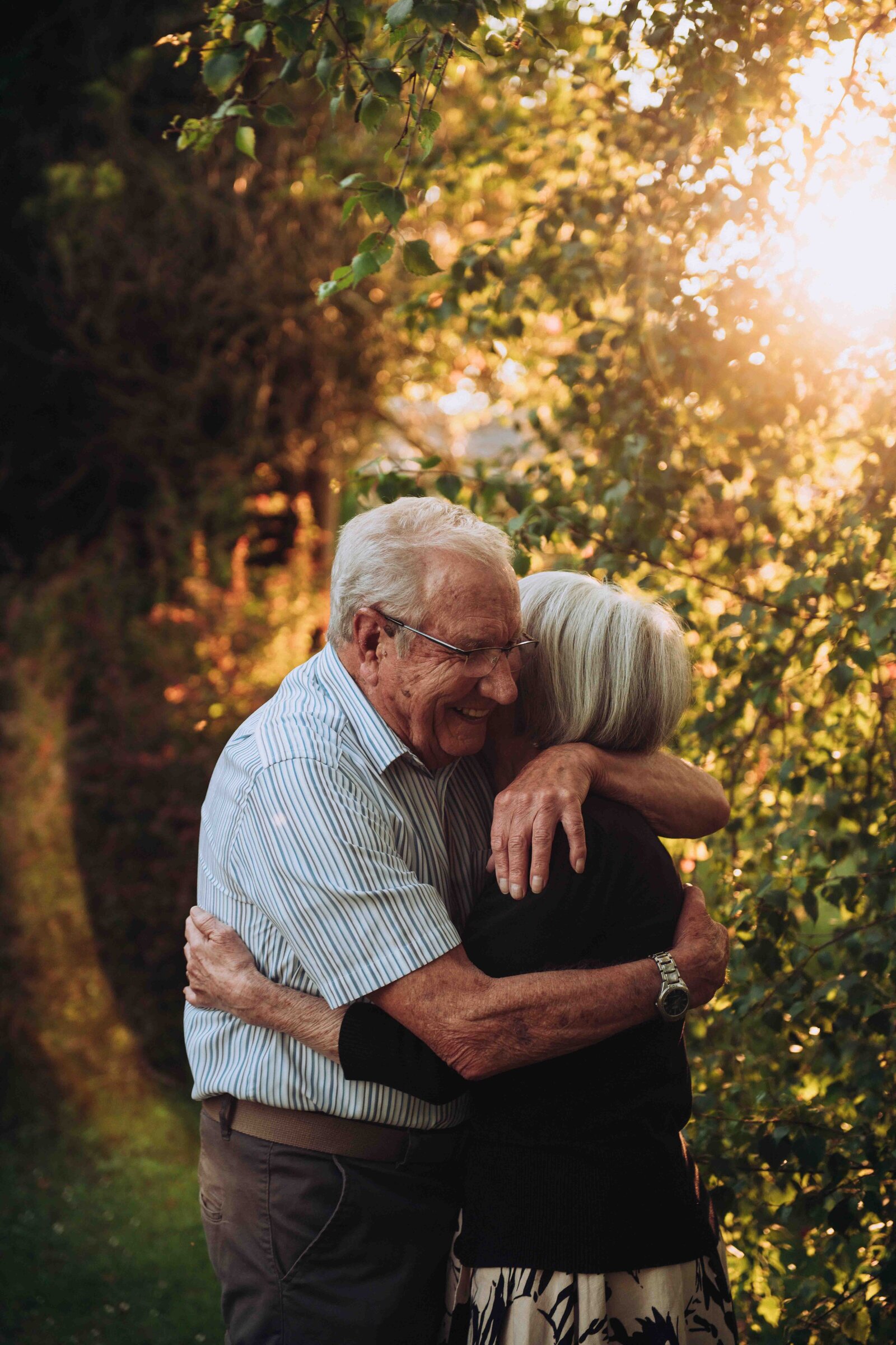 Elderly couple embracing in a garden