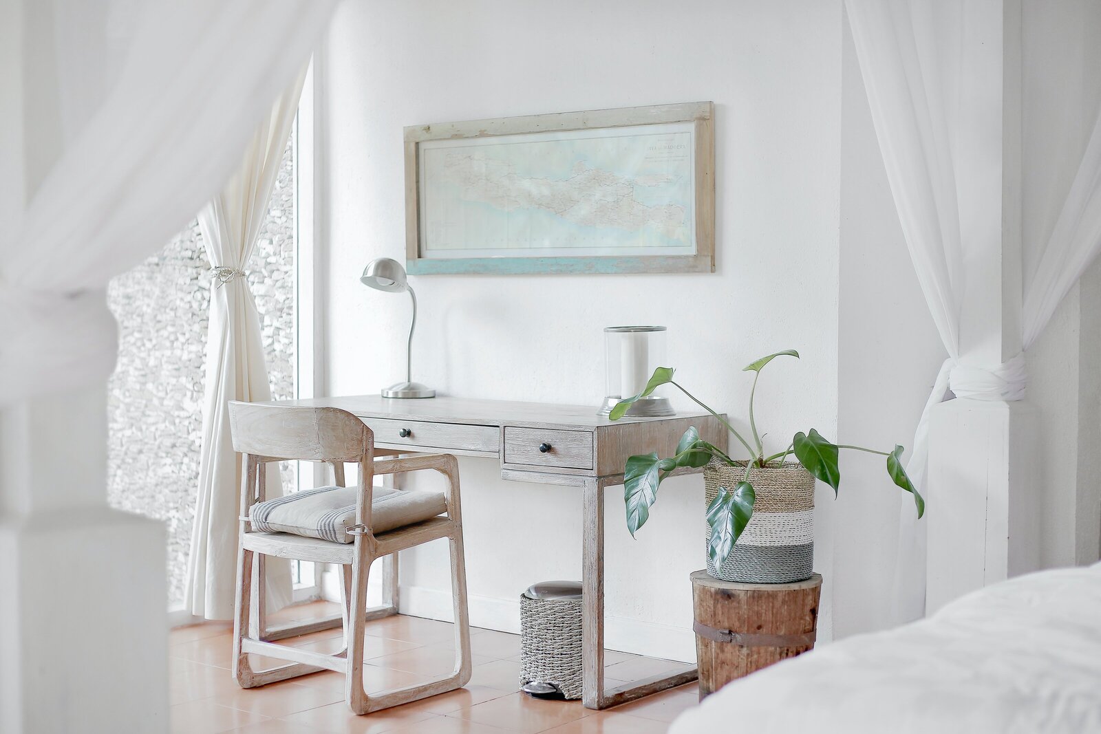 desk in white room with plant
