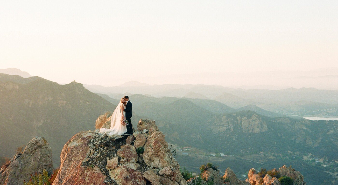Bride and groom on a cliff with a malibu landscape shot on film by My Sun and Stars Co