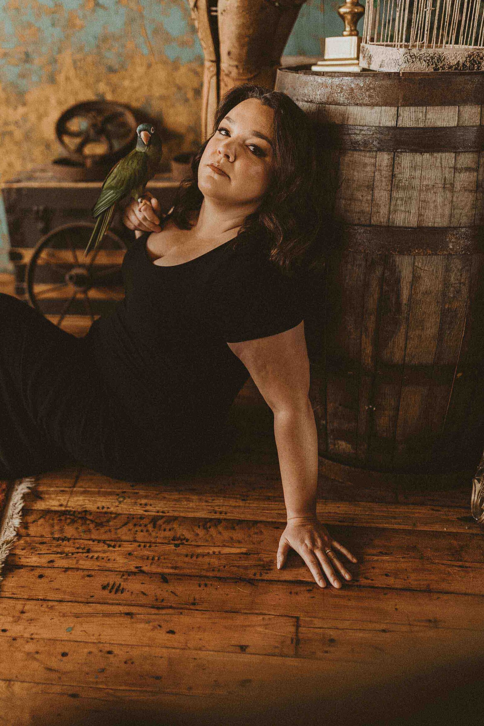 woman sitting on the floor with her bird