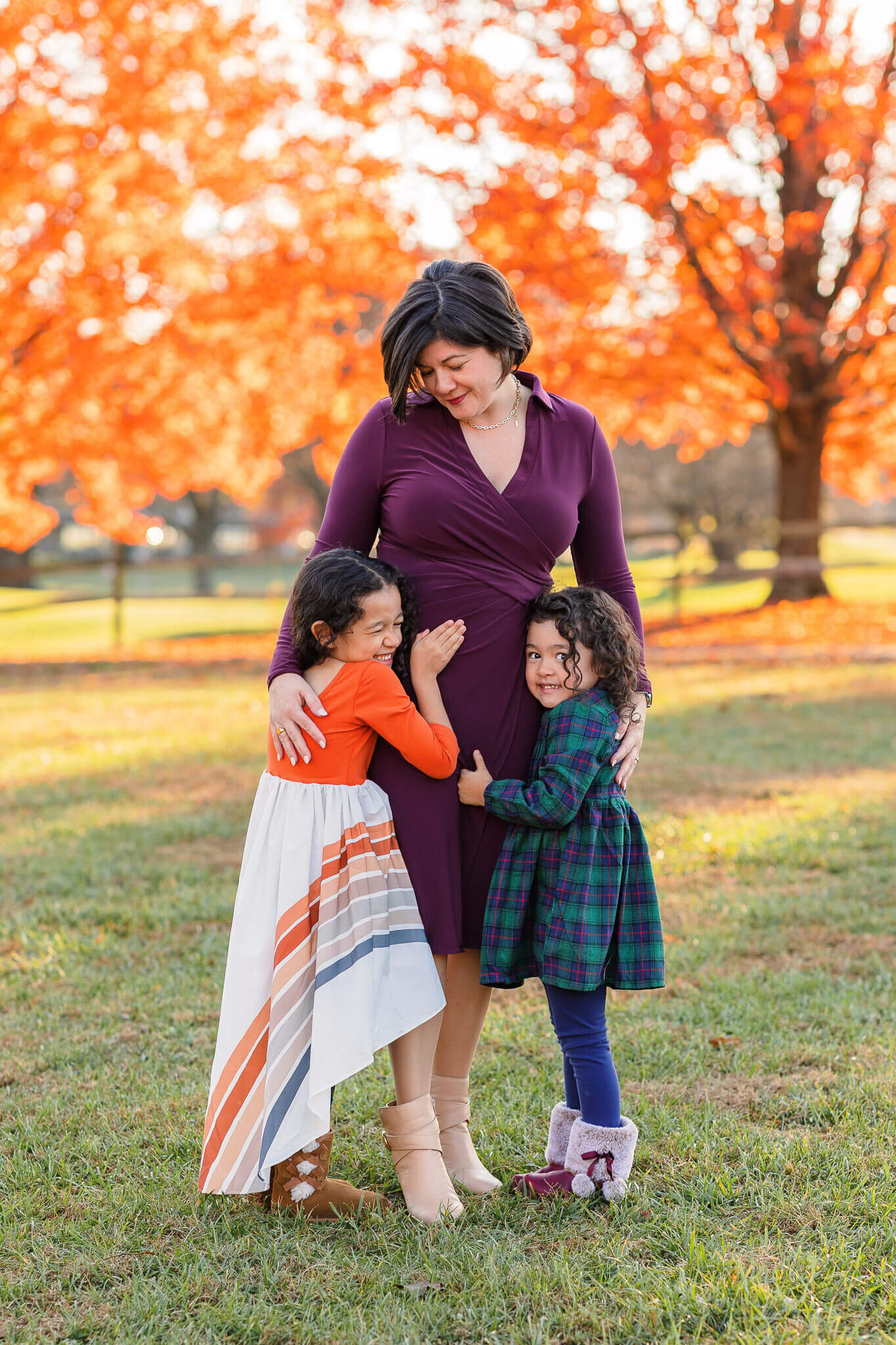 Two girls hugging their mom