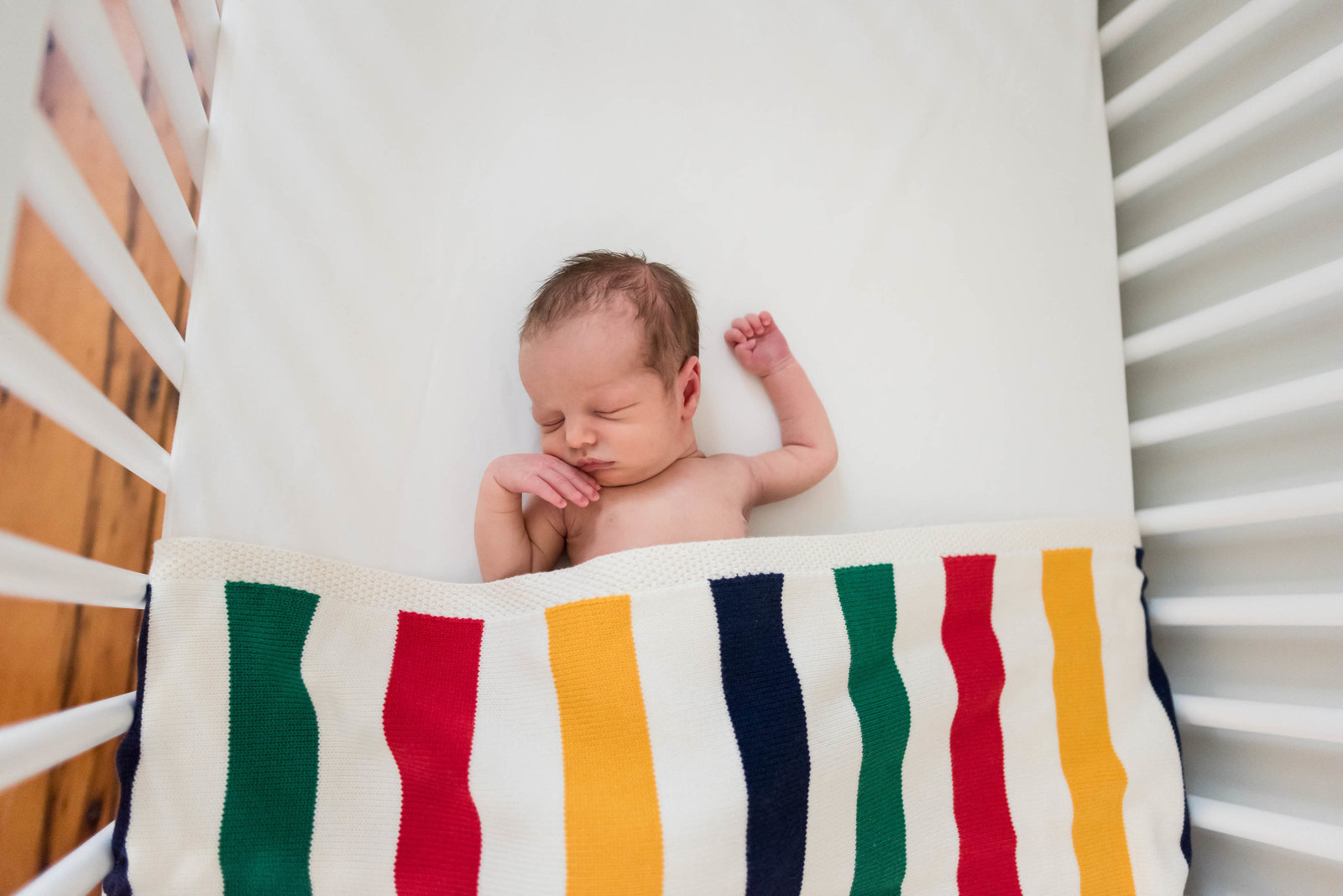 Newborn posed at home lifestyle session Boston in crib