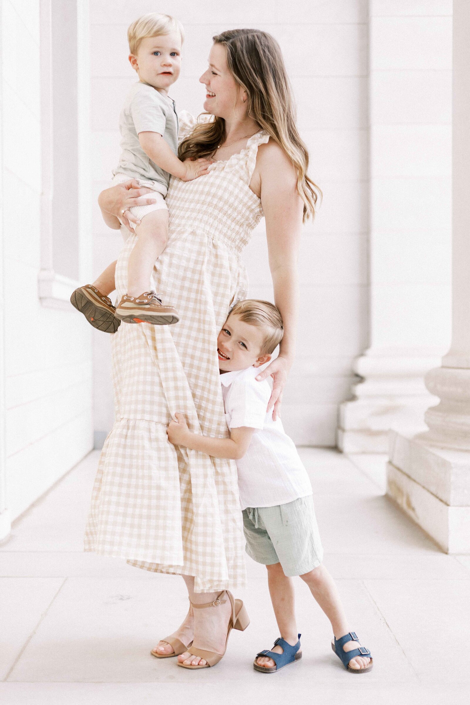 kids hugging mom during maternity photos in peoria illinois 