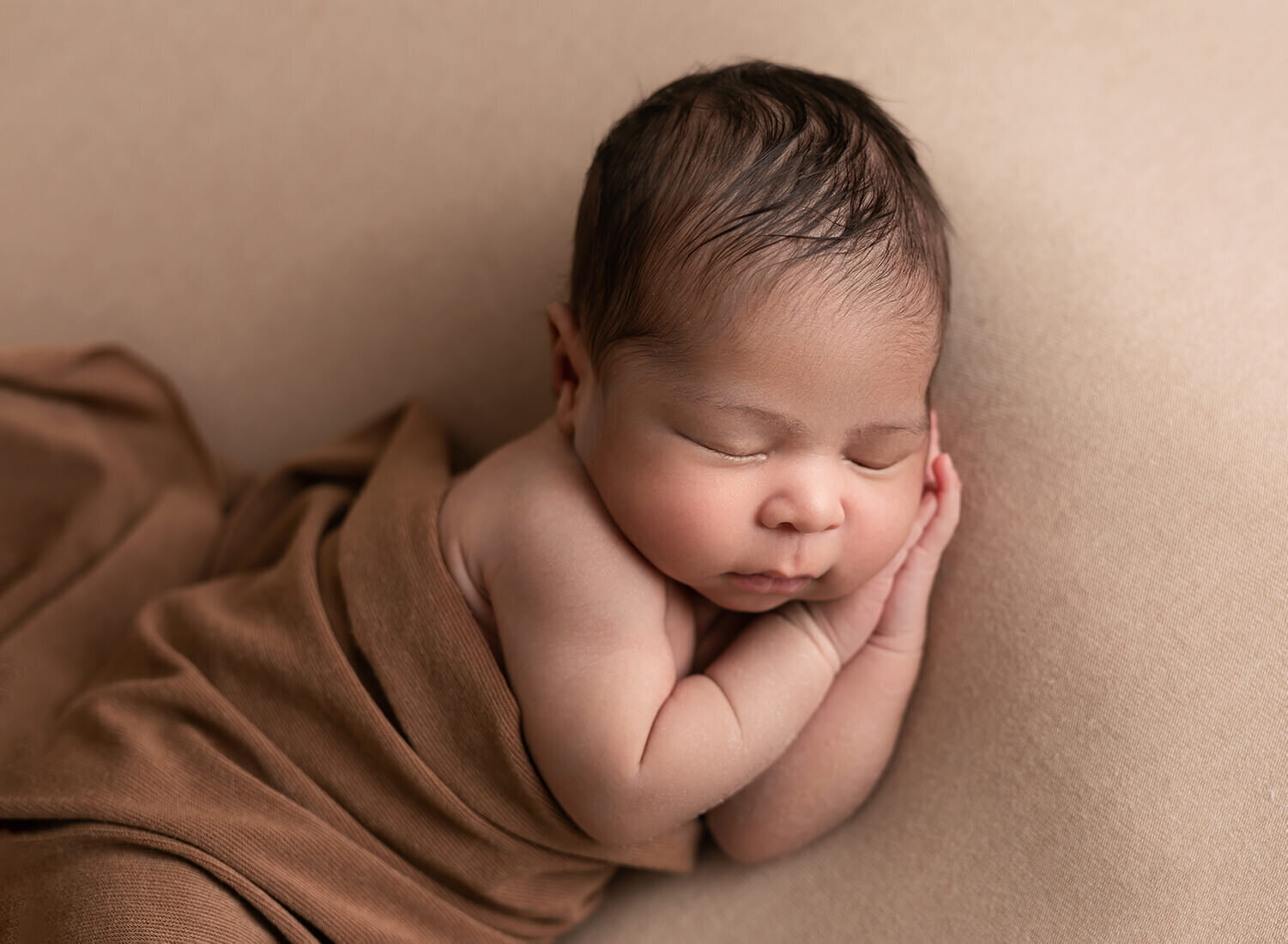 baby boy, laying  on his side on a neutral backdrop.  Photographed in Atlanta by Mariela Duval Photography