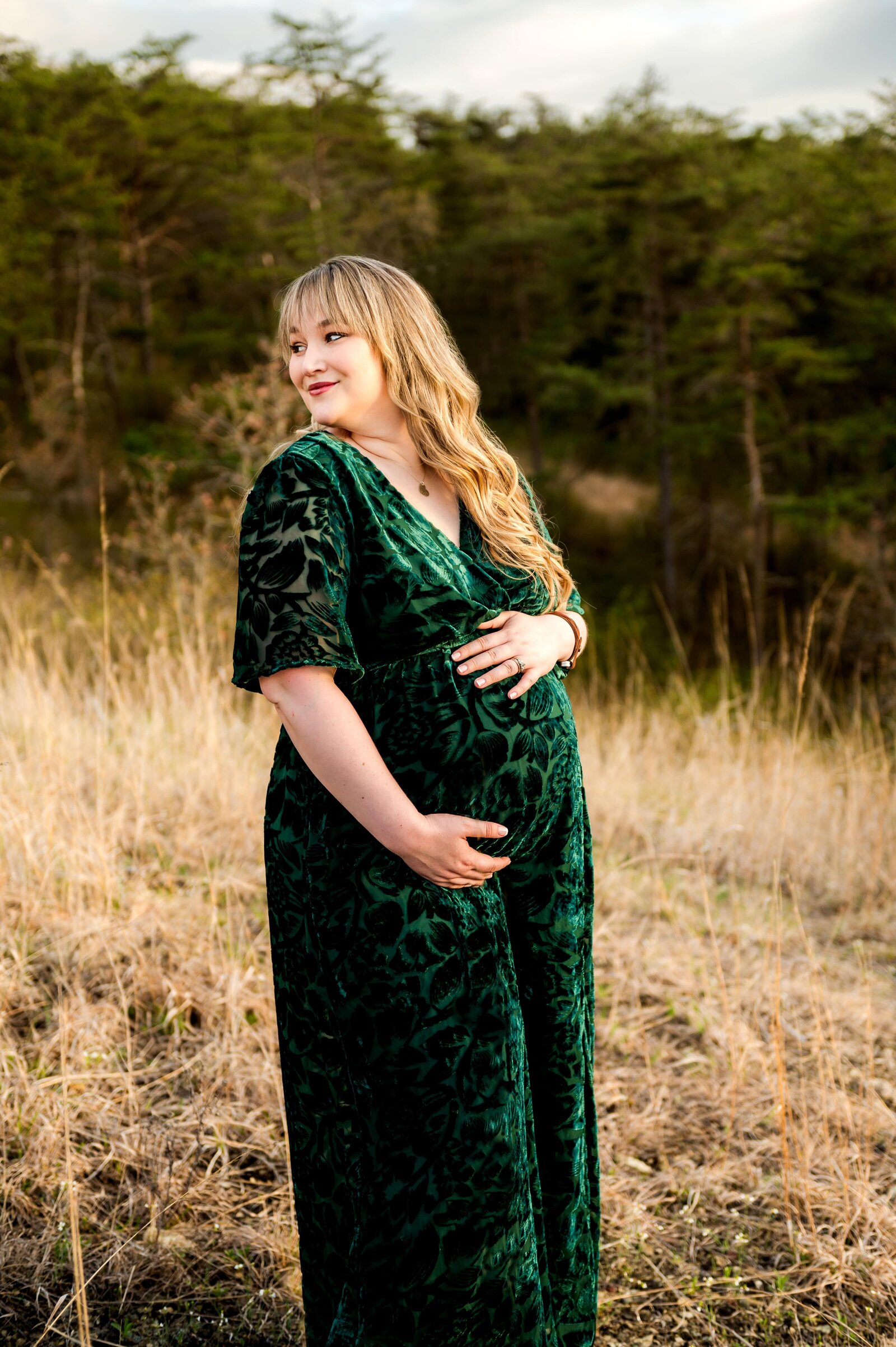 pregnant mom in a field holding her belly