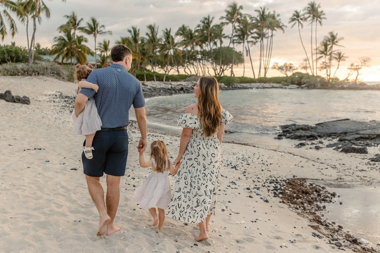 family walking down the beach at fairmont orchid hotel in hawaii