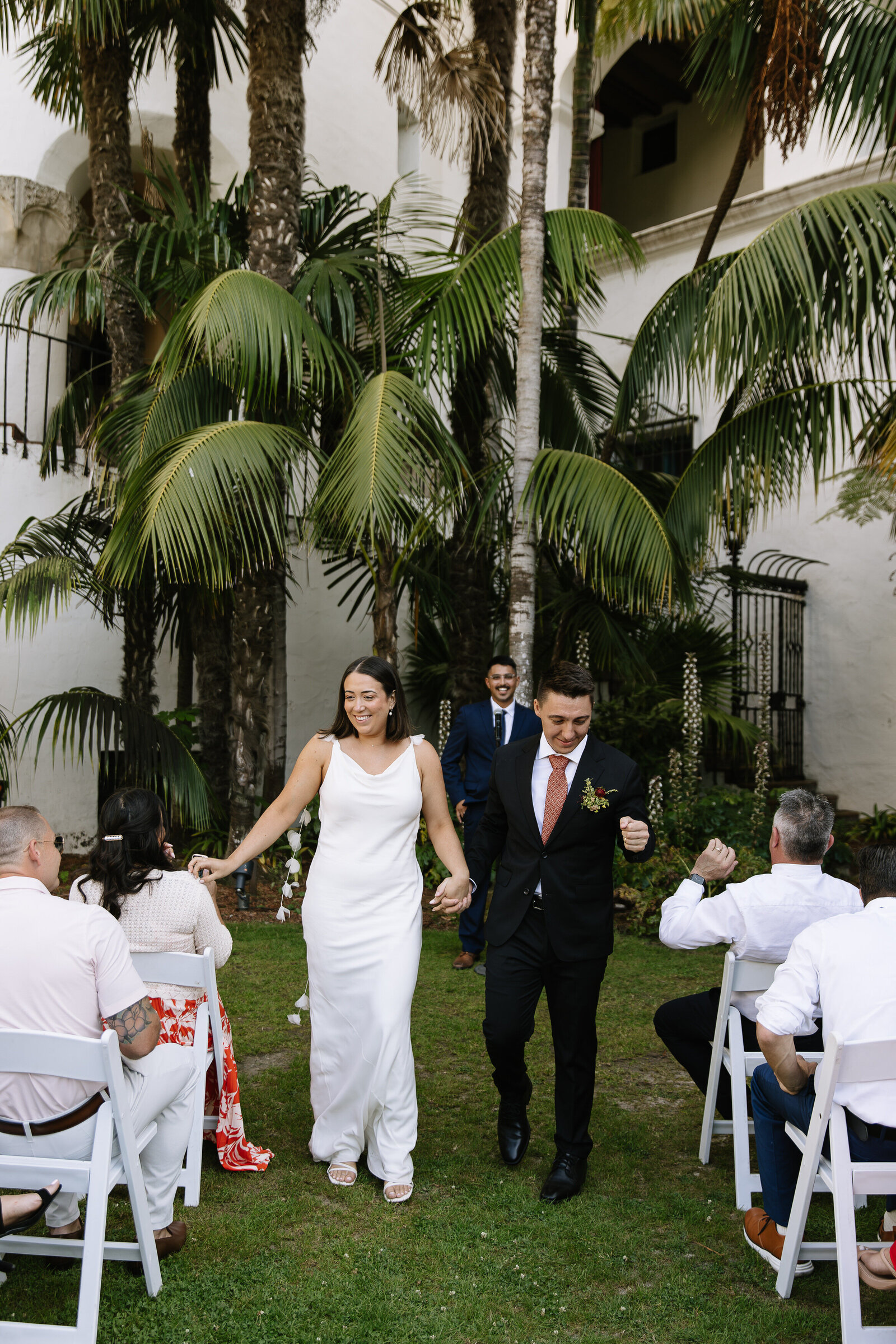 Bride and groom celebrating down aisle by Northern California wedding photographer