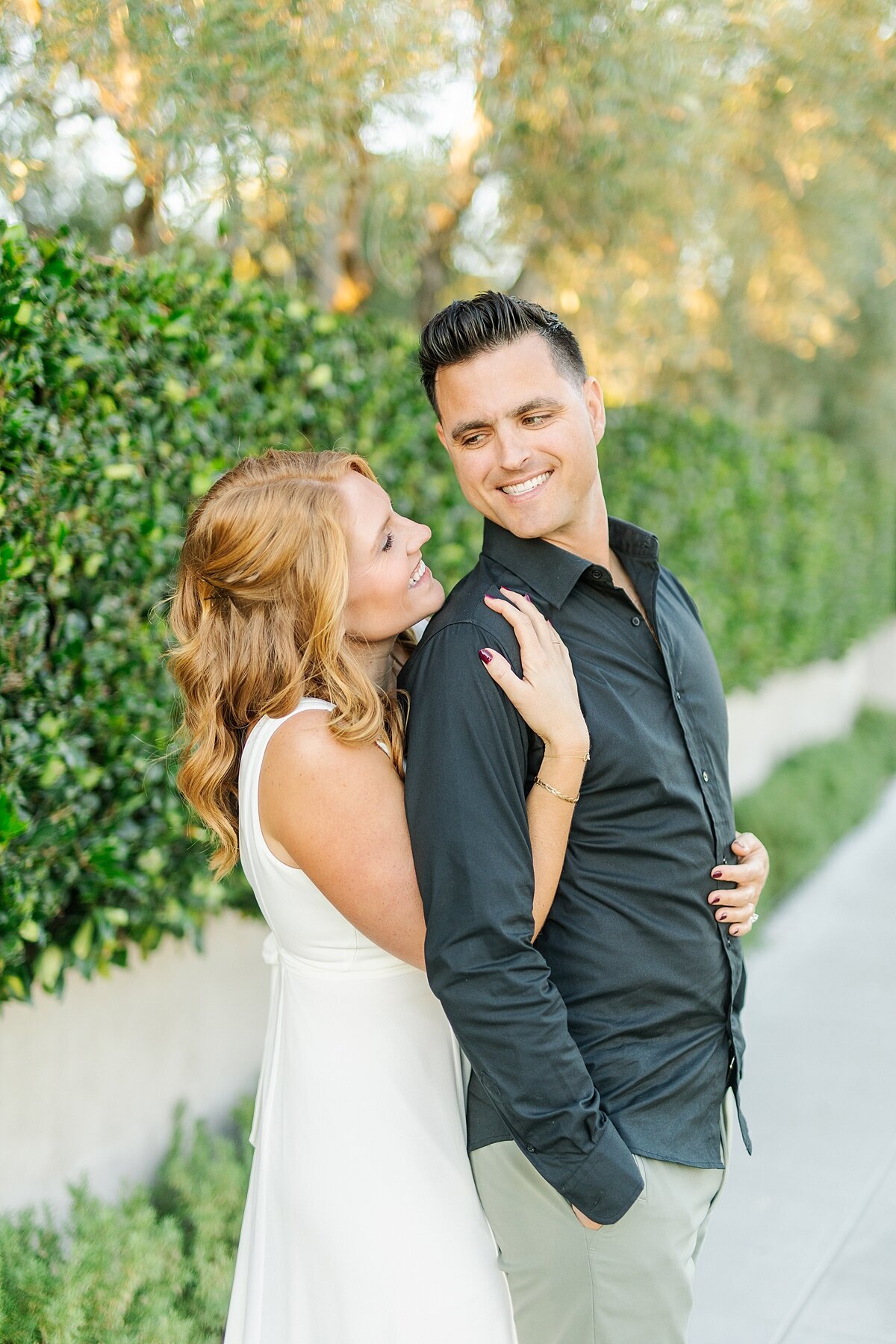 Engaged couple taking photos together in the neighborhoods of San Diego on Coronado Island.