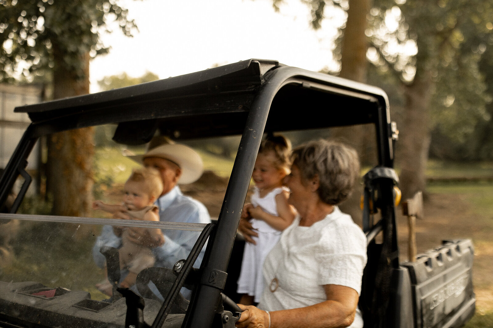 Iowa grandparents riding in Gator with grandchildren
