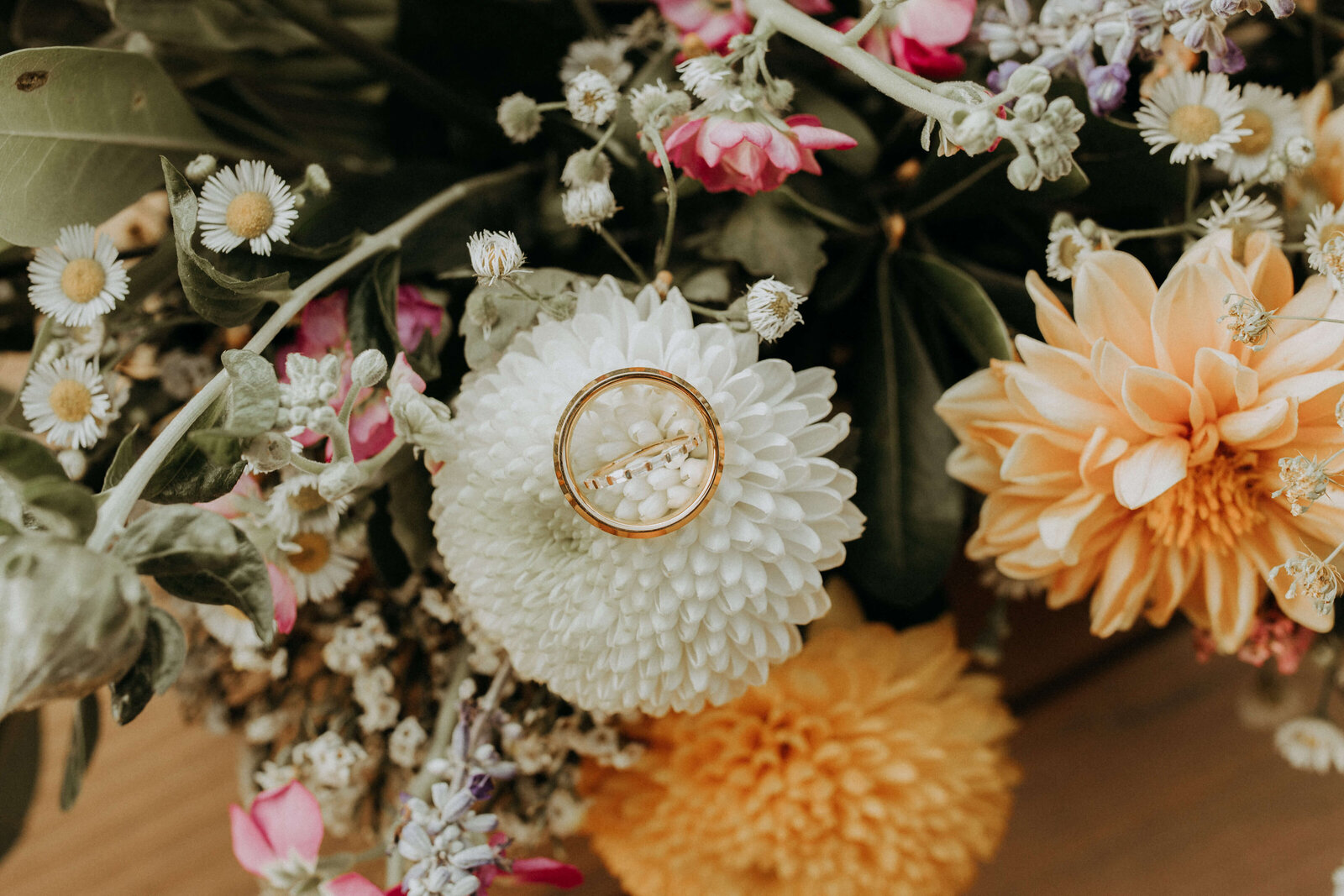 wedding ring on colorful bouquet