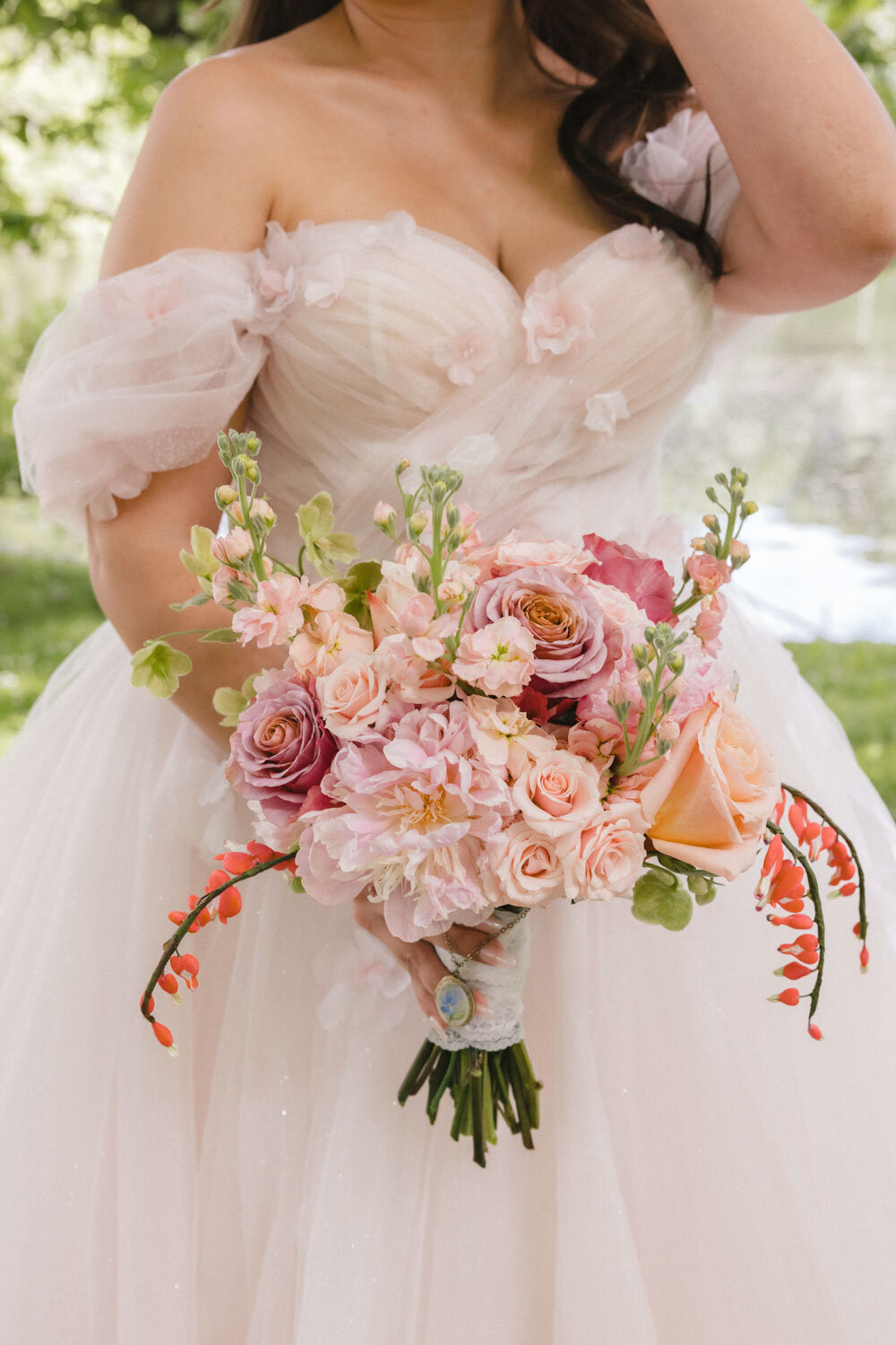 Close-up of bridal bouquet with pastel pink and peach flowers