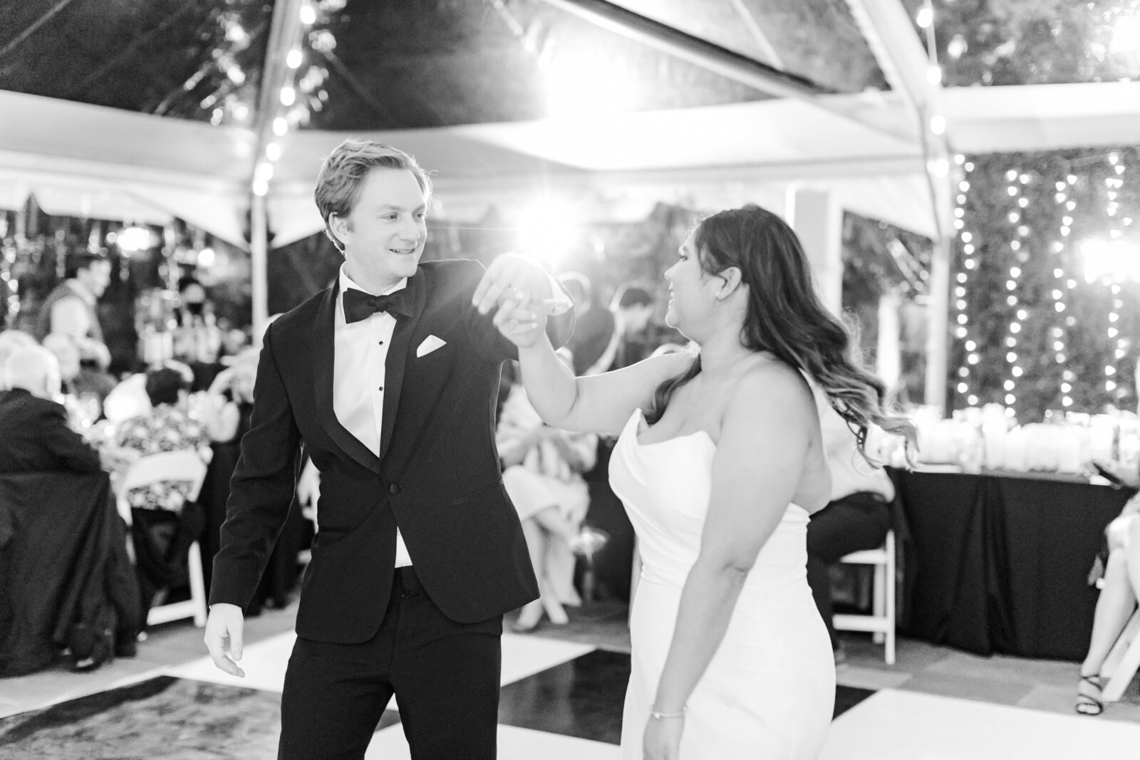 19_black_and_white_image_of_couple_during_first_dance_clear_tent_reception