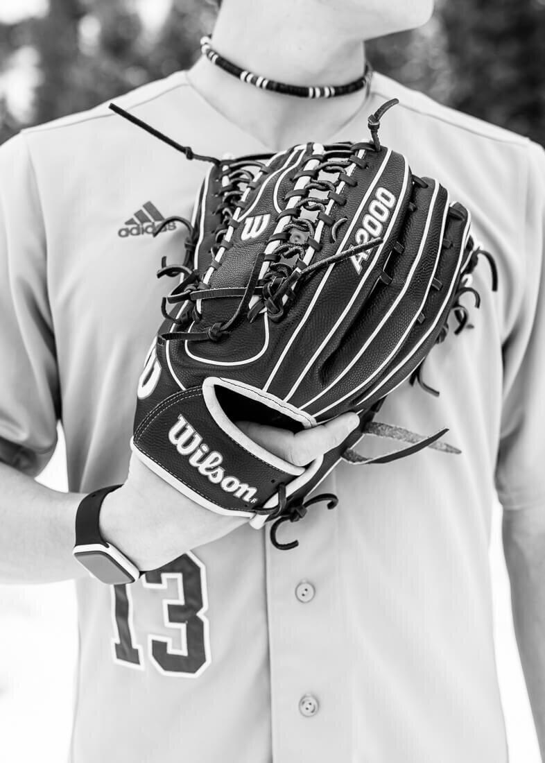 Black and white senior photography of a closeup of a baseball glove