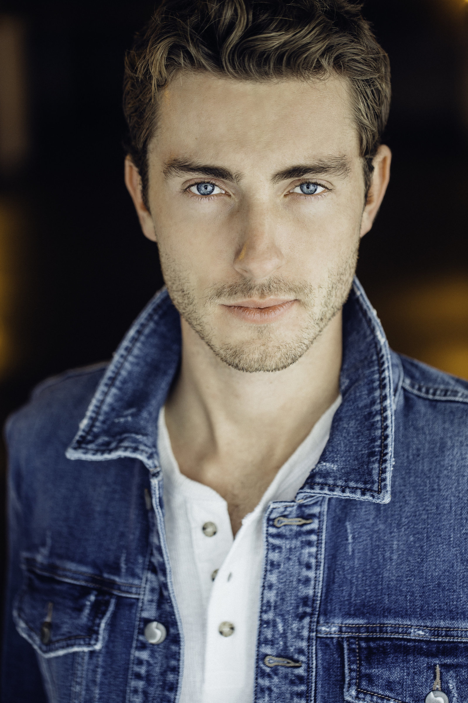 Headshot Photo Of Young  Man In Blue Denim Jacket And White Polo
