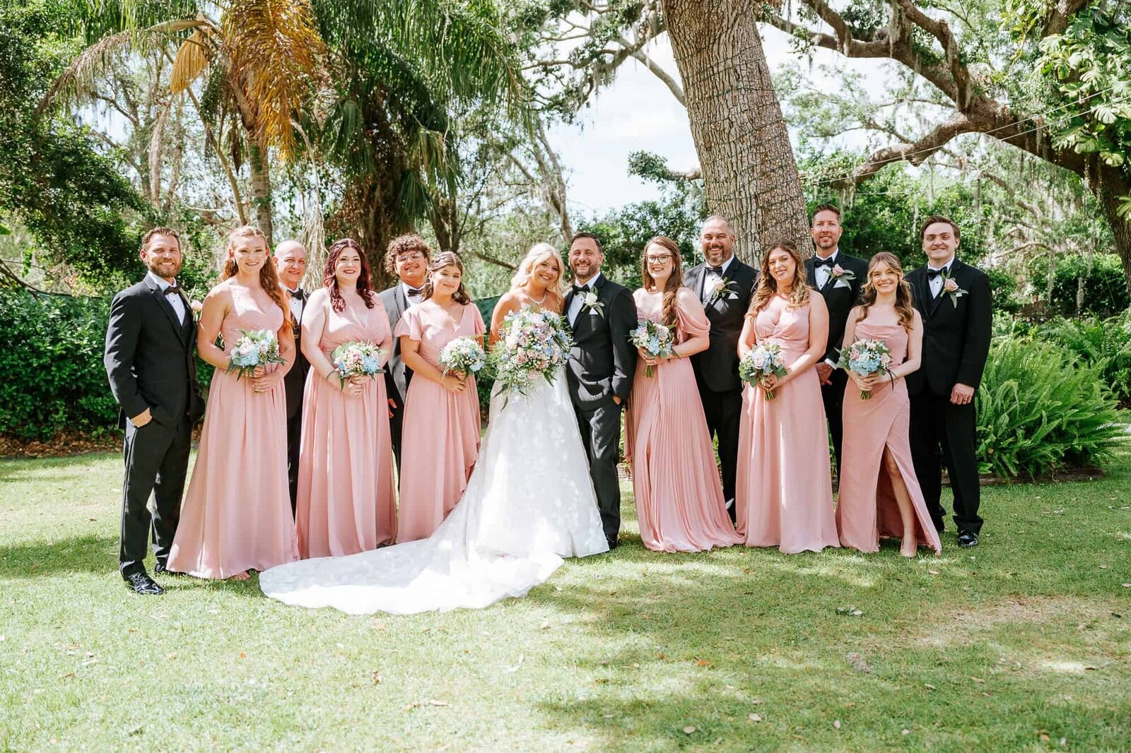 Bridal party posing in front of the white pergola ceremony site at Baker’s Ranch. Tampa Wedding Photography