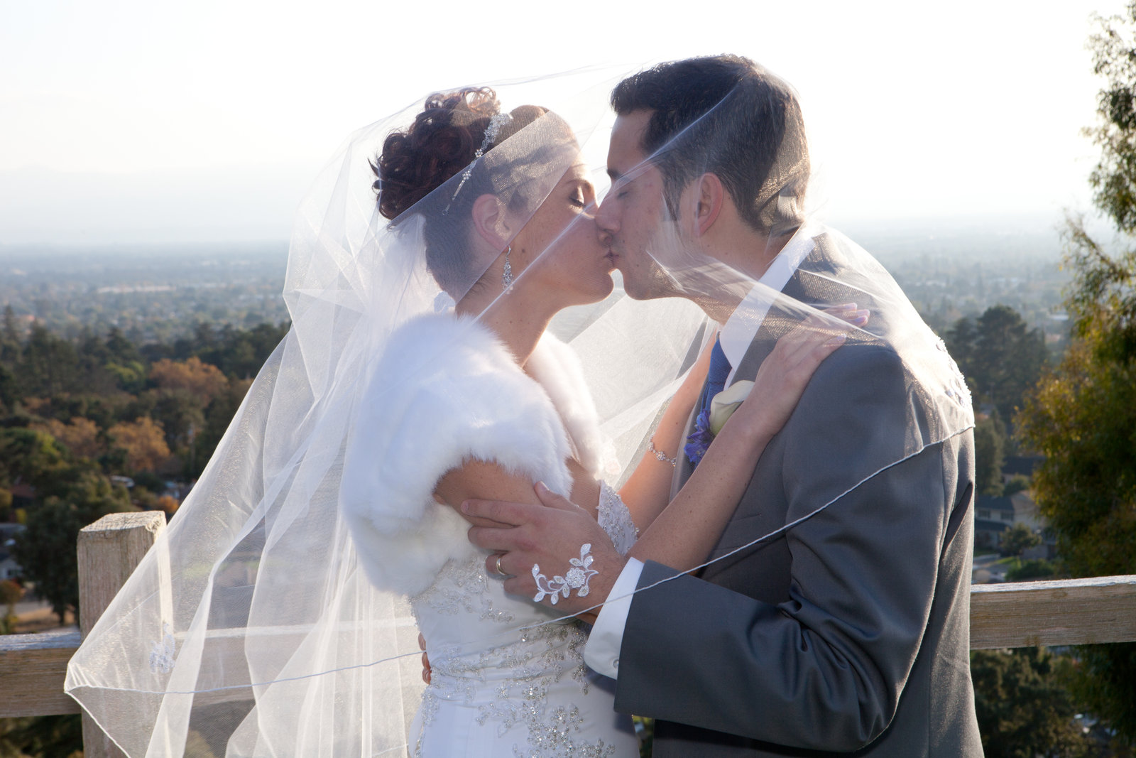 Gorgeous backdrop provides the perfect scenery for bride and groom's kiss