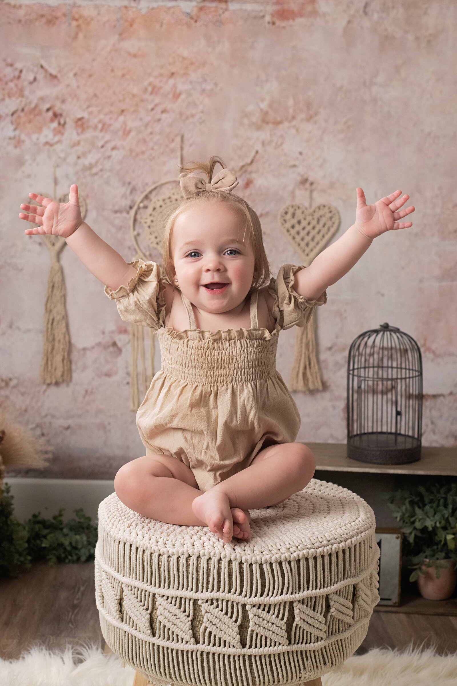 happy baby girl with hands up boho decor