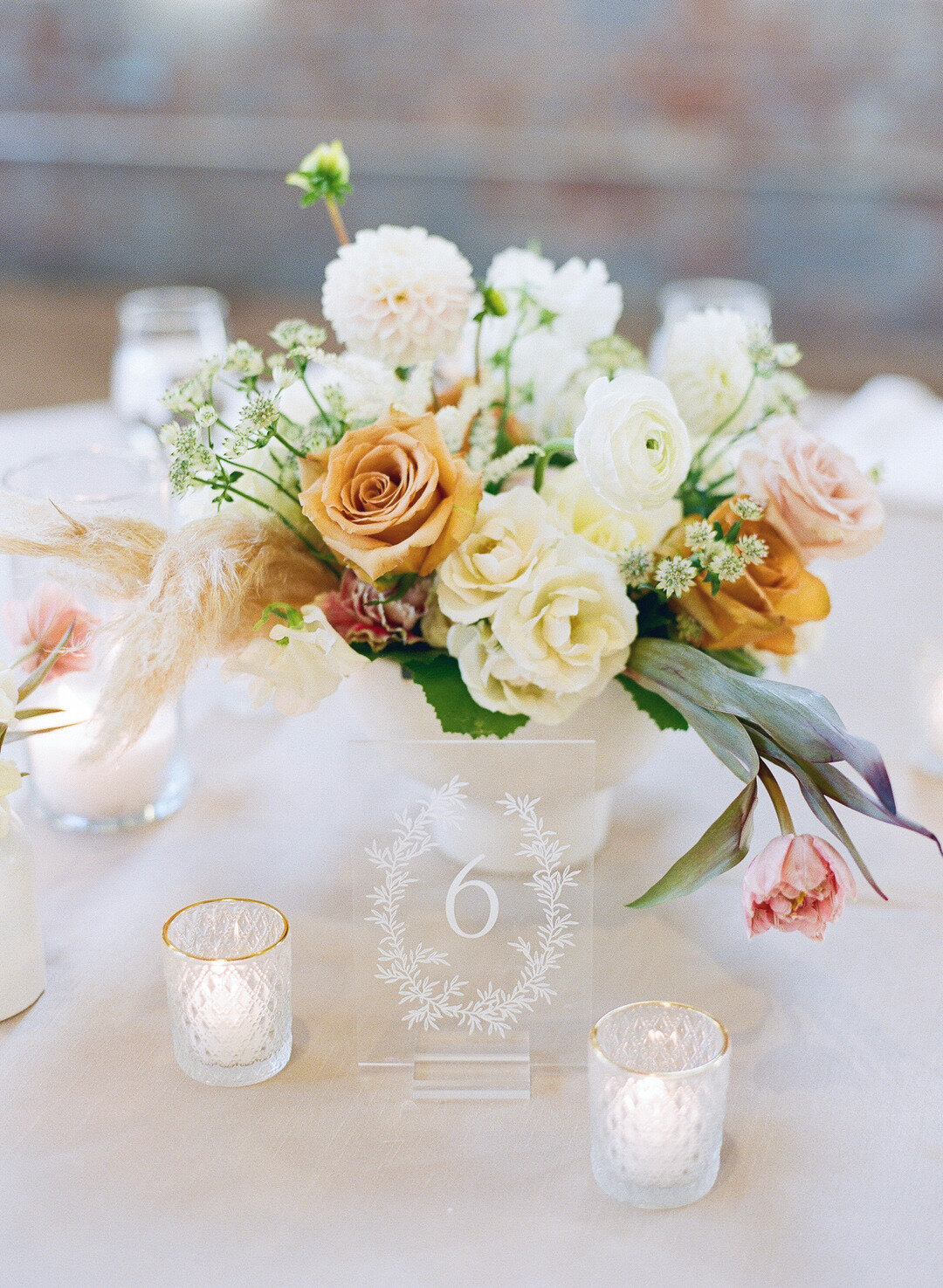 Wedding reception floral centerpiece and clear acrylic table number