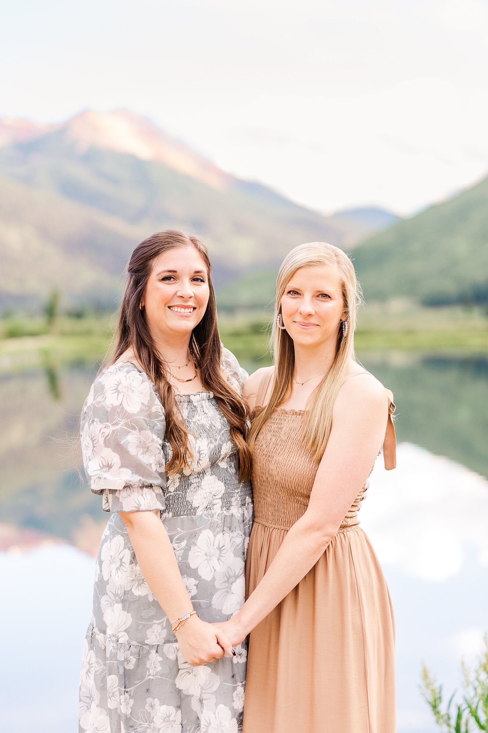 sisters hold hands for photo in ouray