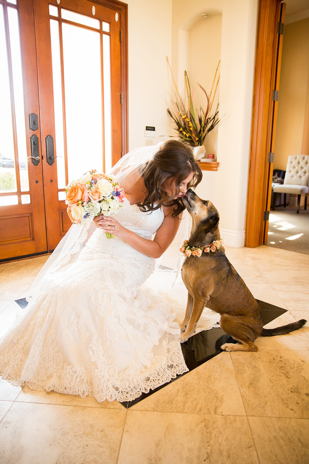 bride with her dog kissing her cheek