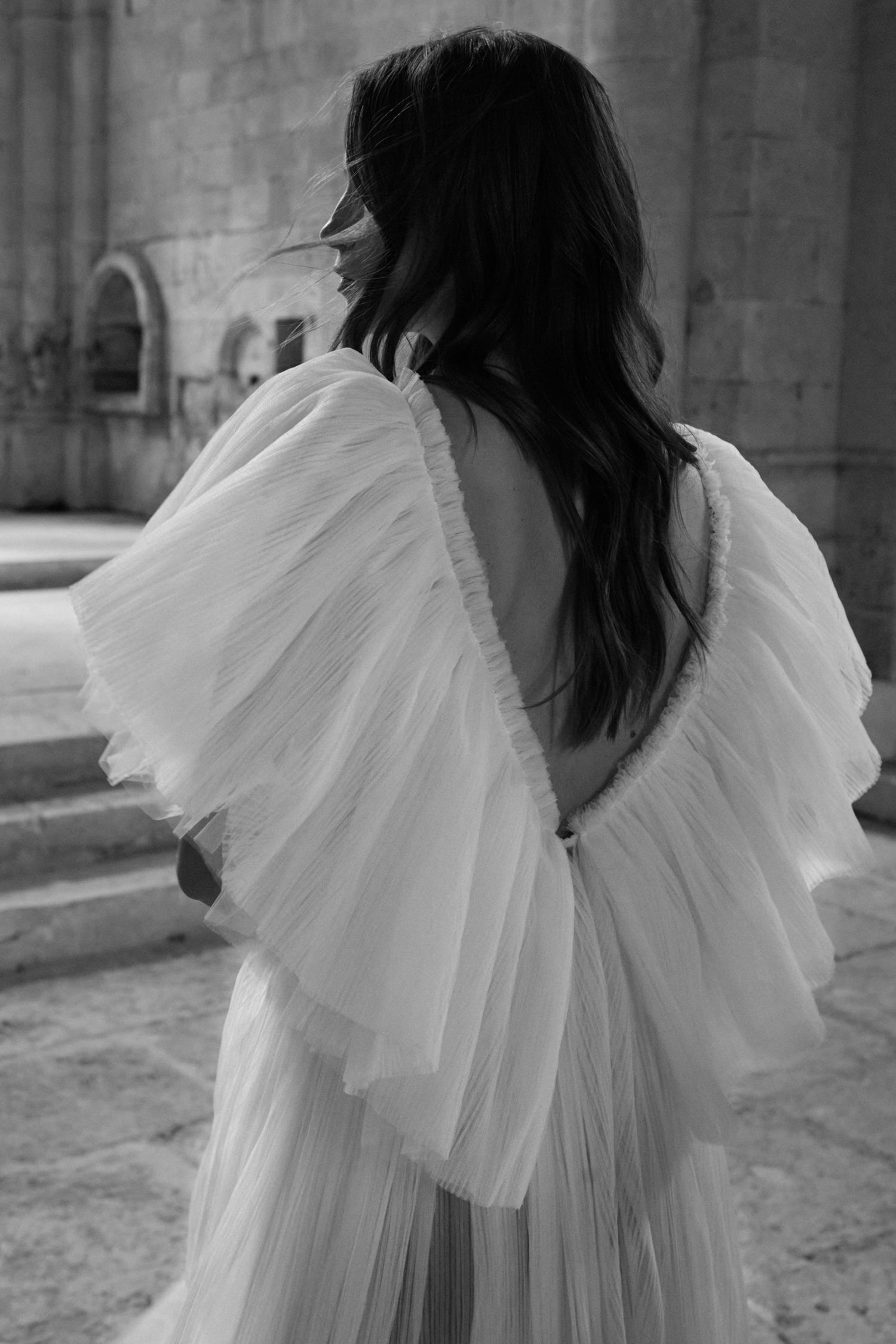 black and white image bride wearing tulle wedding dress with sleeves