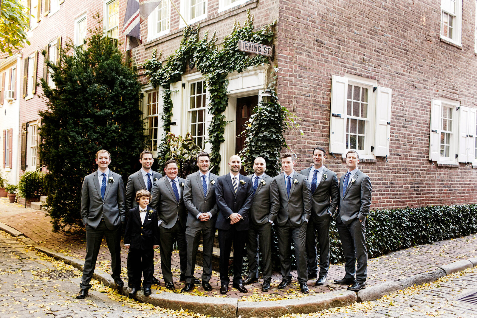 groomsmen in city cobblestone street