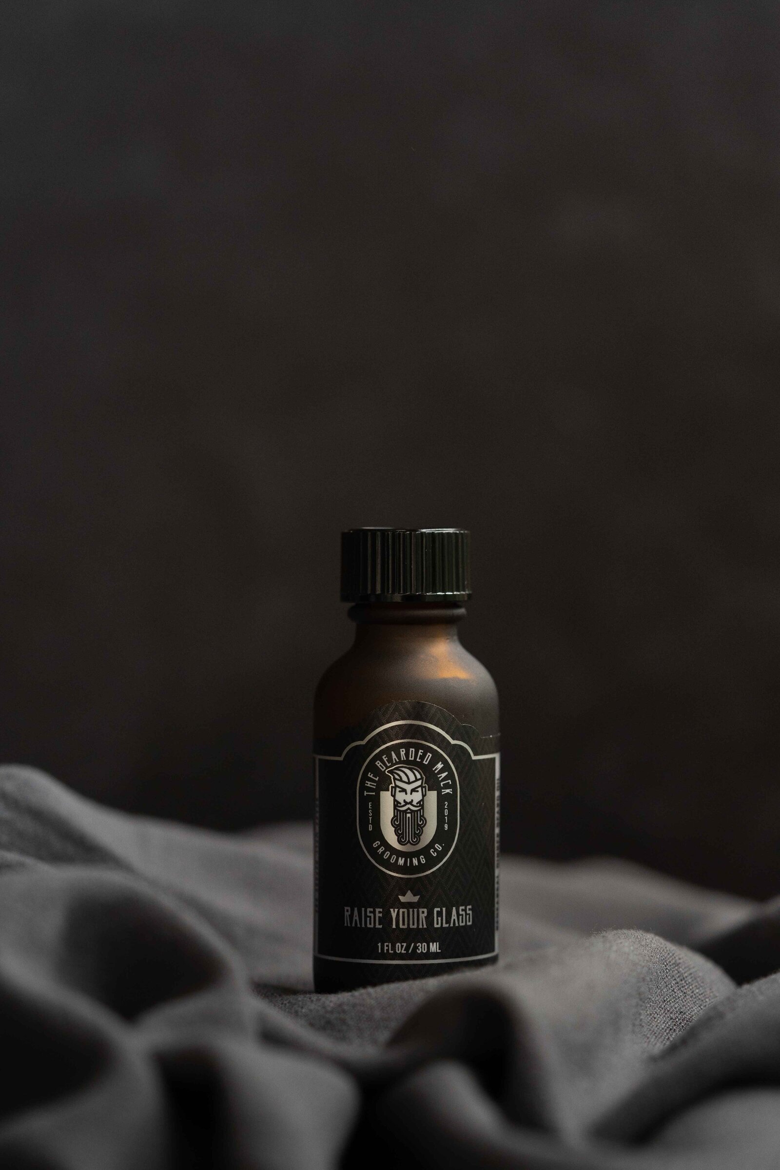 bottle styled with fabric taken by Herndon,VA product photographer