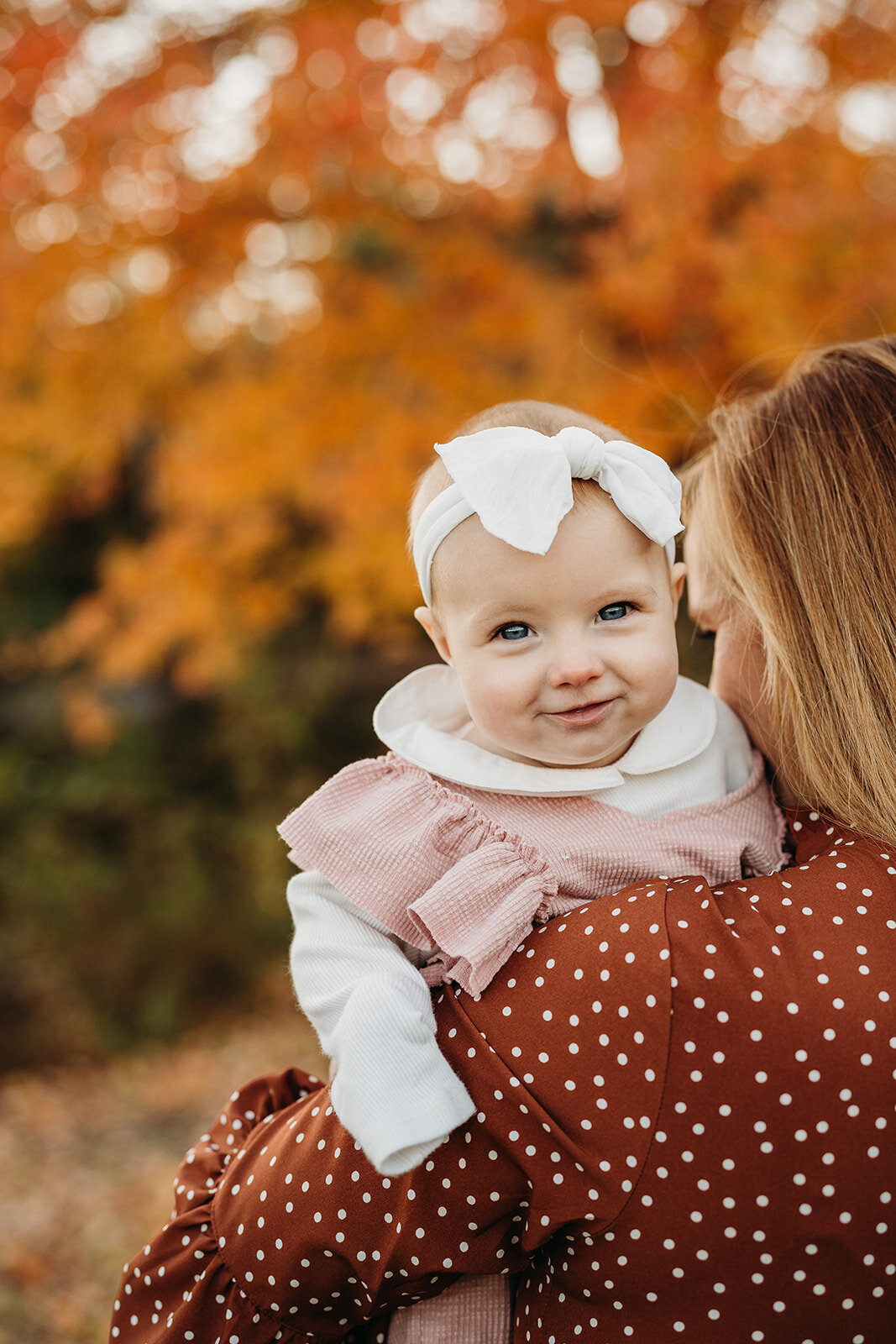 baby girl in blush dress in october family photos