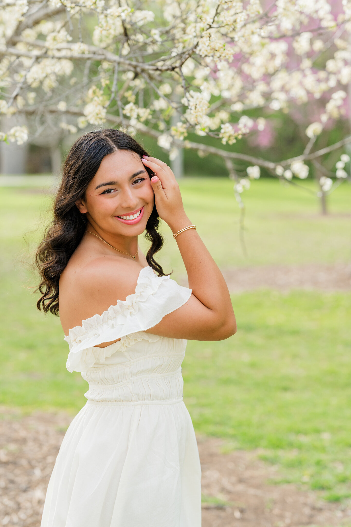 Canyon High School senior posing in front of blossoms at Landa Park
