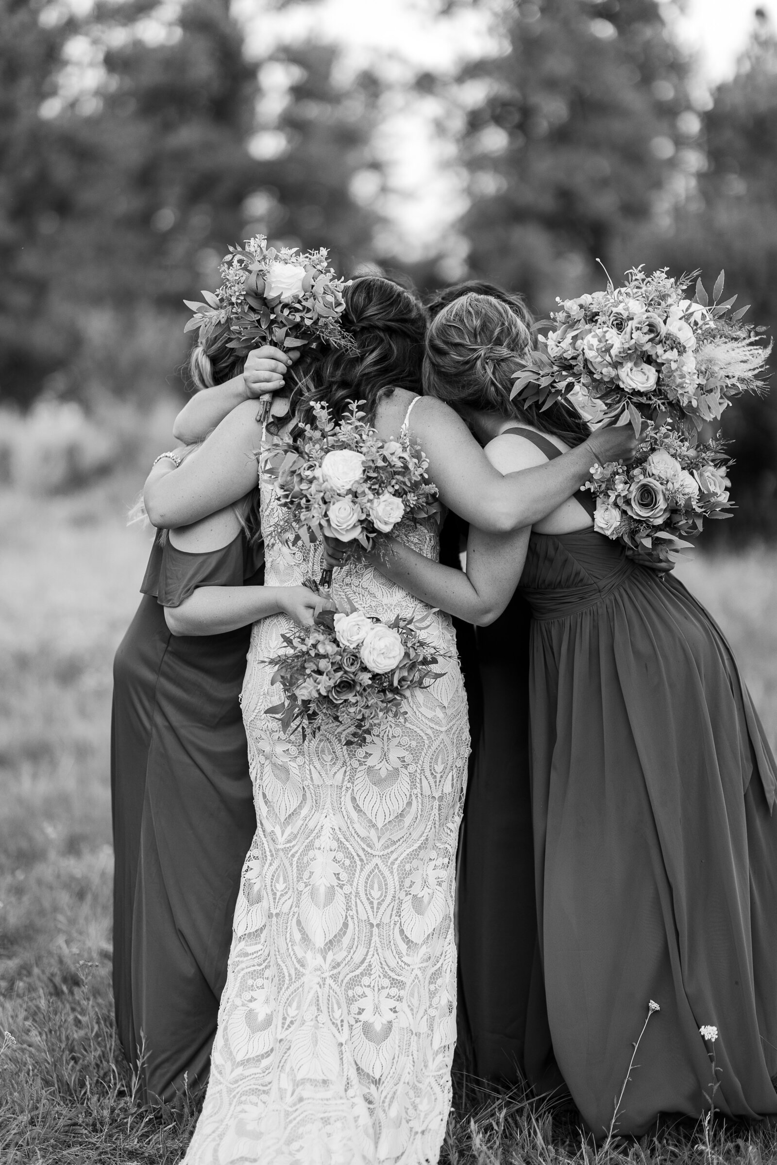 black and white image of bridesmaids hugging