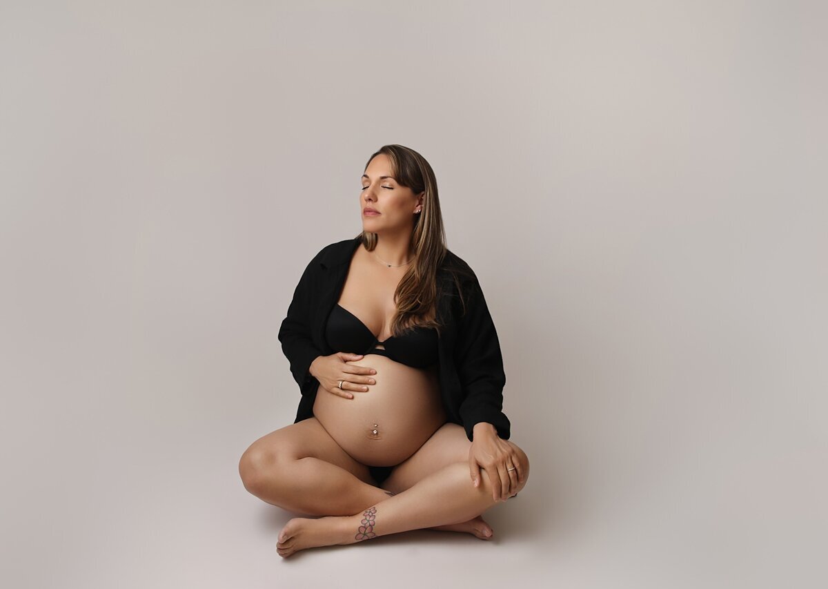 pregnant mom sitting in black