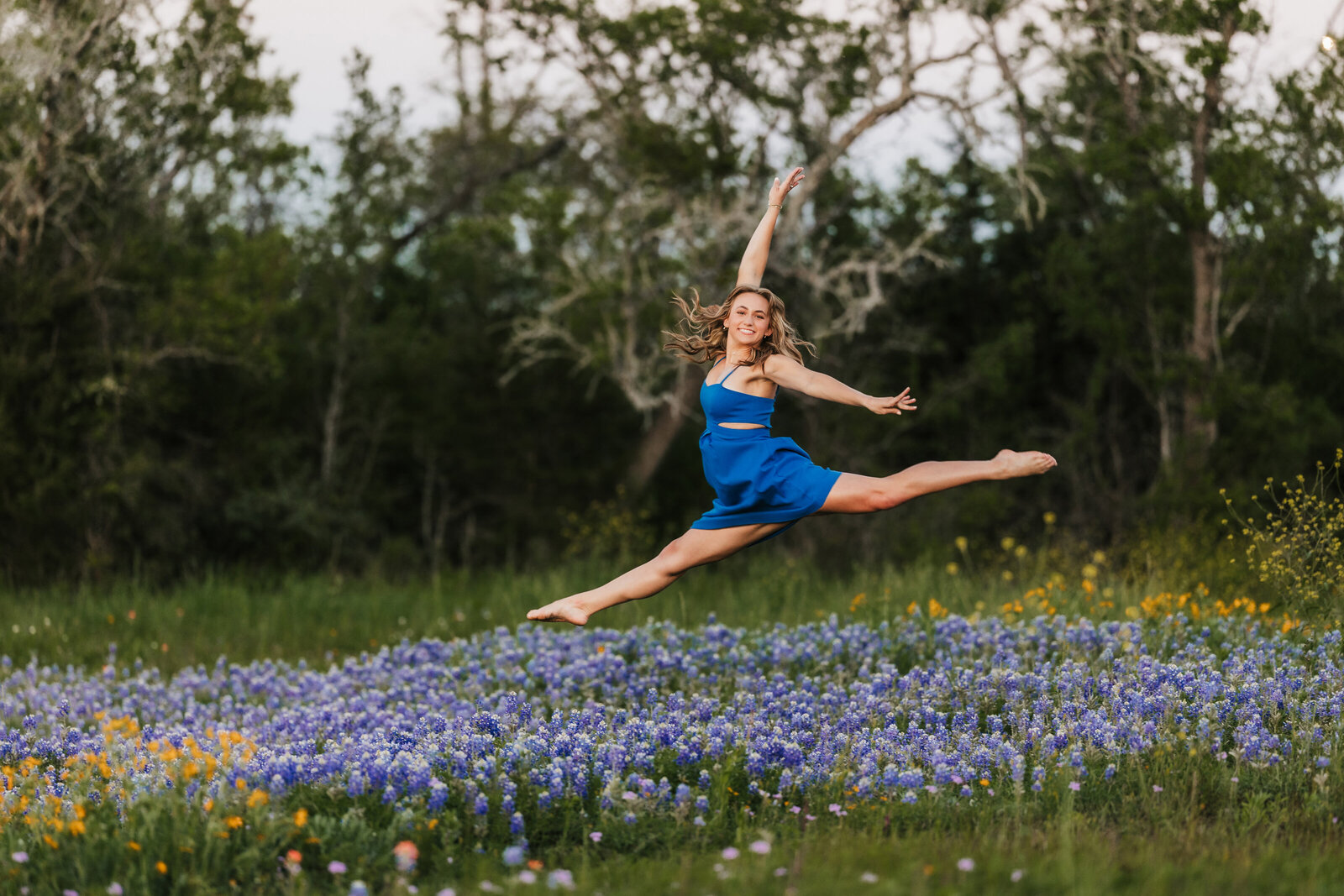high-school-senior-leaps-in-flowers