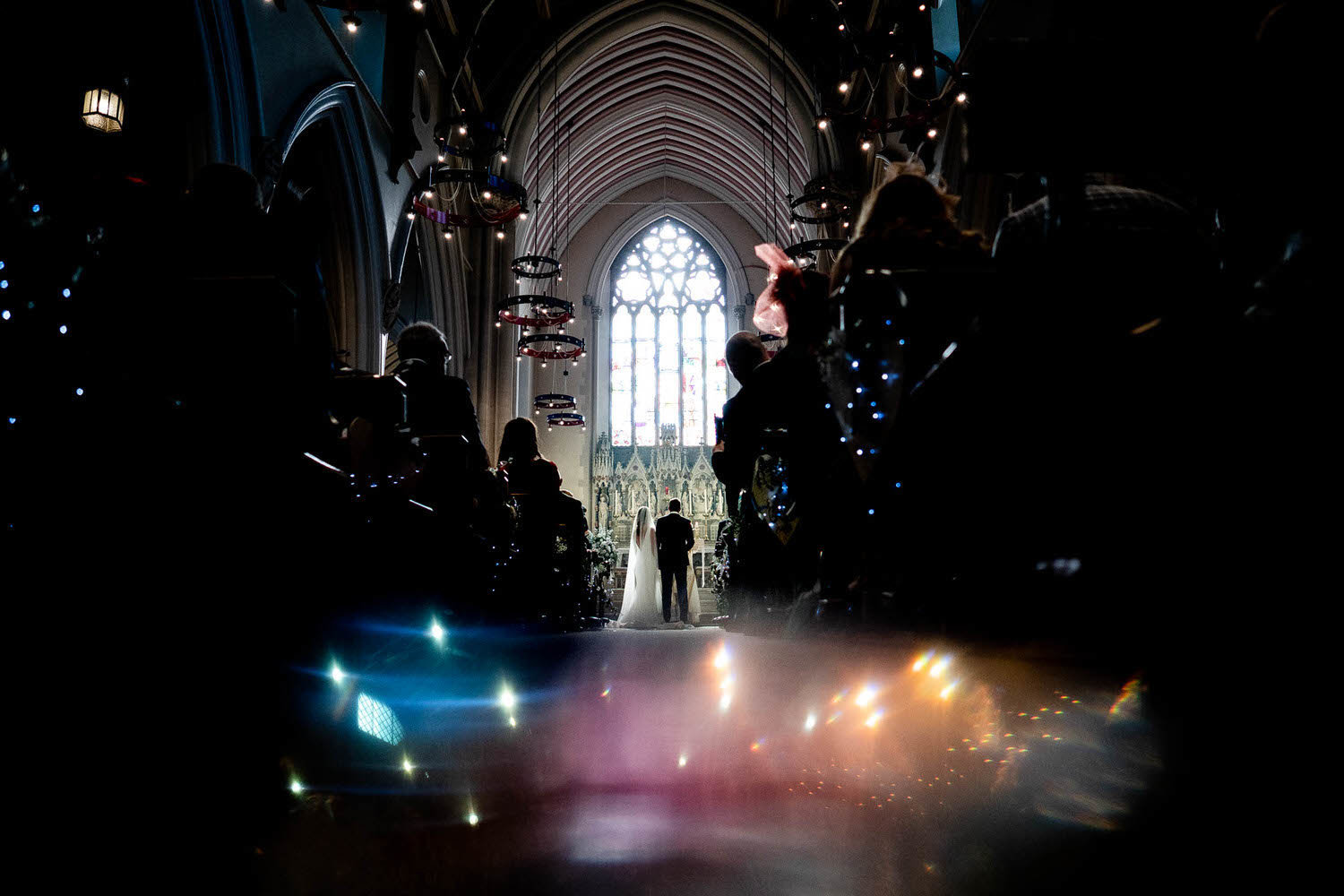 bride and groom down the aisle of a church using prisms