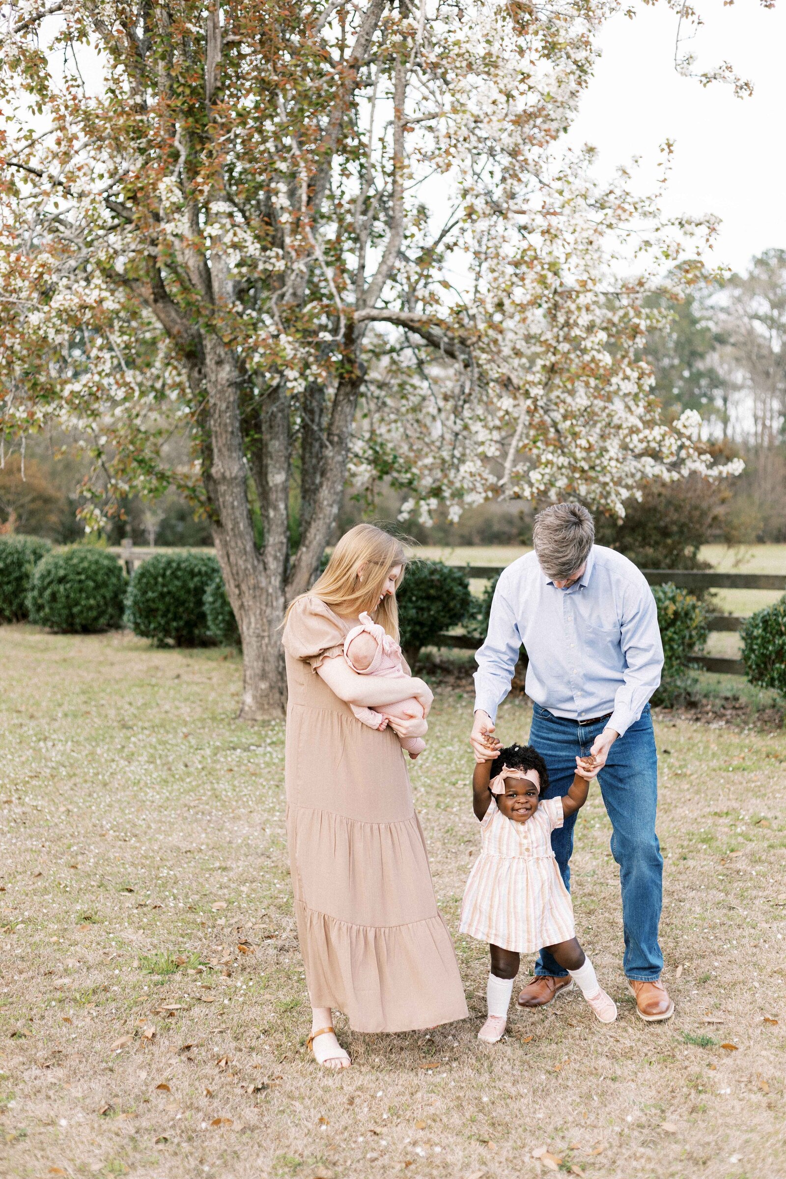 family walking with newborn baby and daughter during peoria illinois newborn photos 