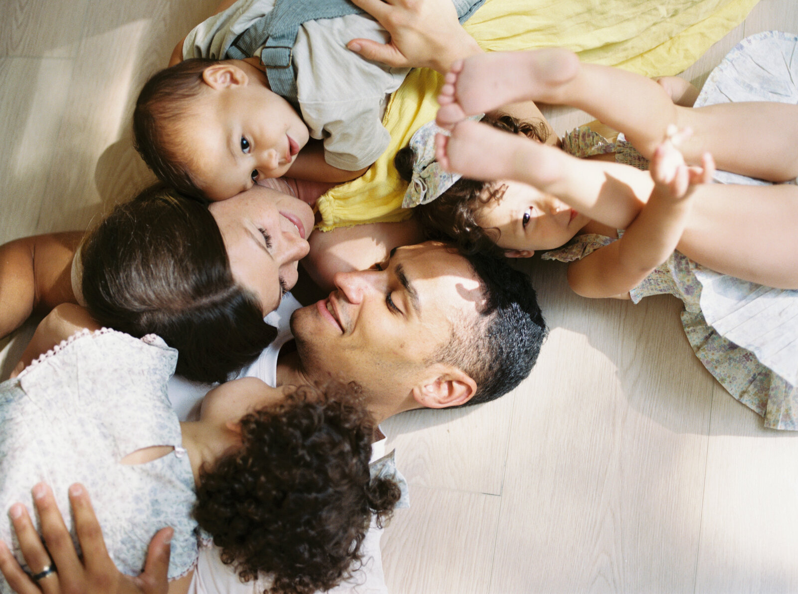 family laying on the floor during Raleigh family photos with Morgan Williams Photo