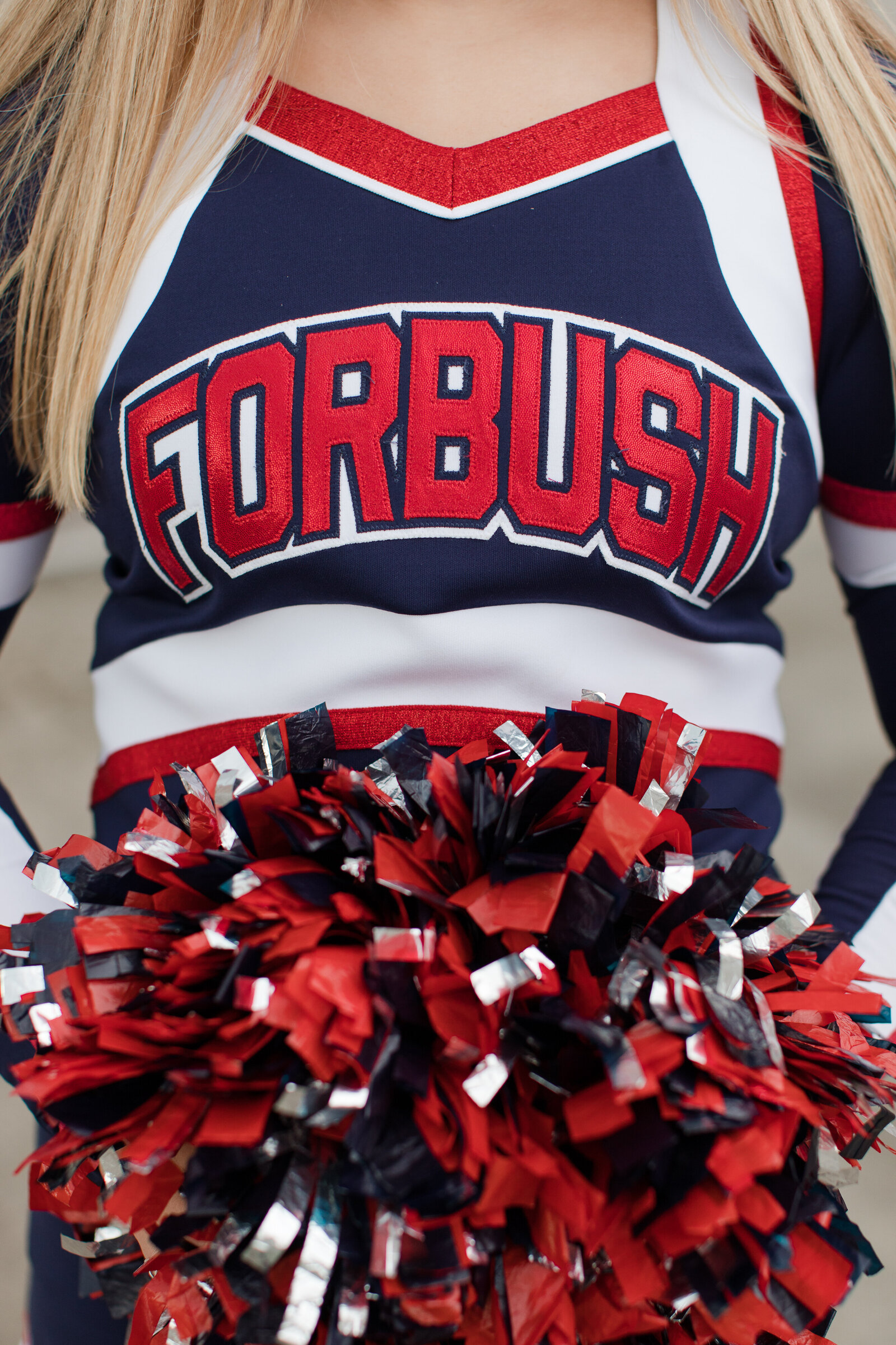 detail shot of senior cheer uniform and poms