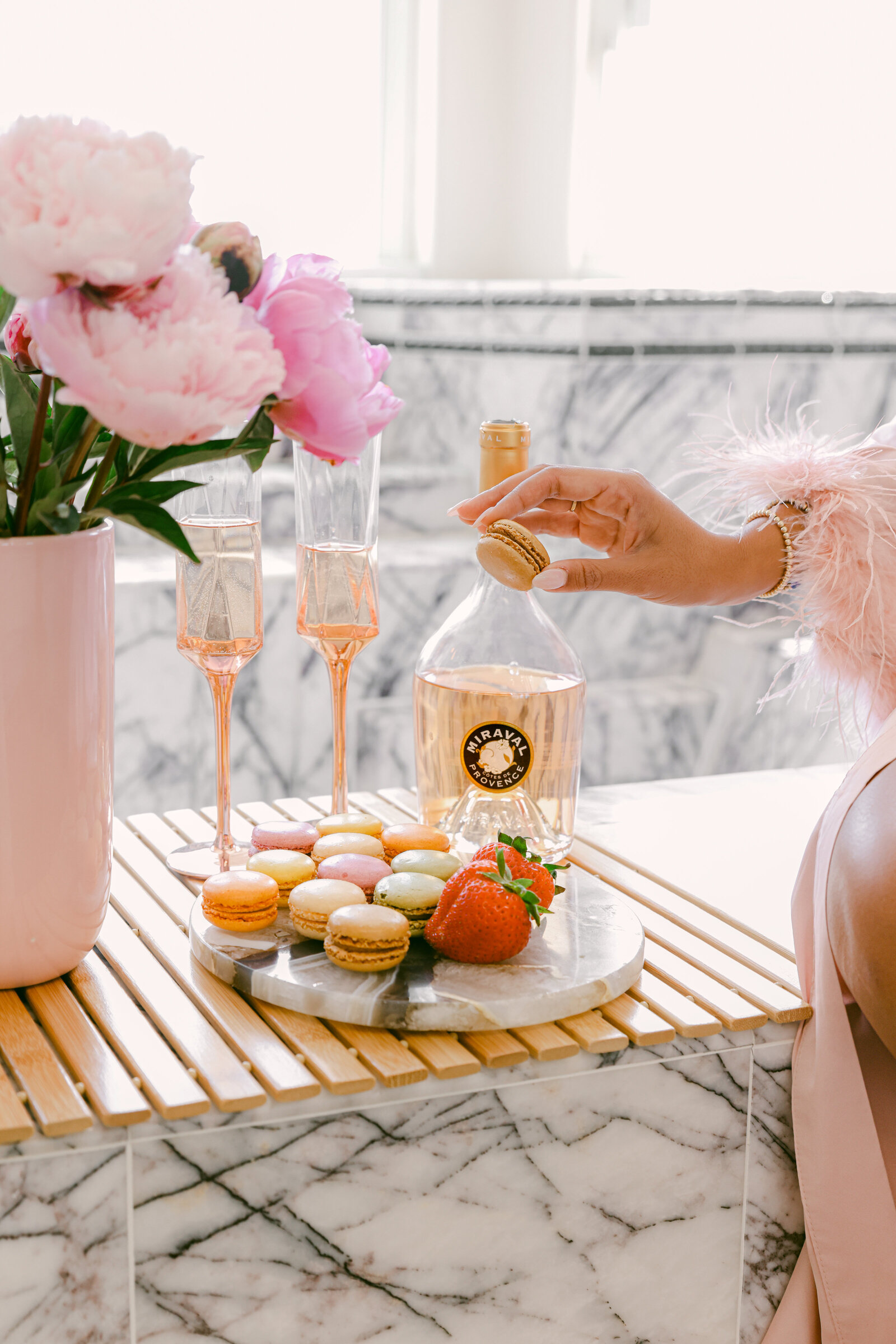 Chic Airbnb Marble bathtub luxe experience with champagne, macarons, and robe